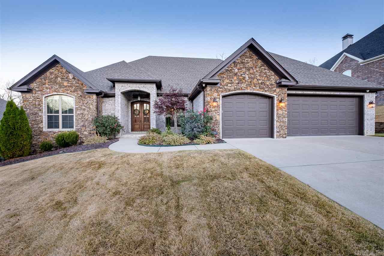 Don't miss this custom Hartness built home. 1.5 Stories with 4 bedrooms on the main level. Upgraded lighting throughout and decorative master bath with freestanding bathtub and lighted mirrors. Covered back patio with fireplace and flagstone patios is a great space for entertaining while overlooking the greenspace. A MUST SEE!