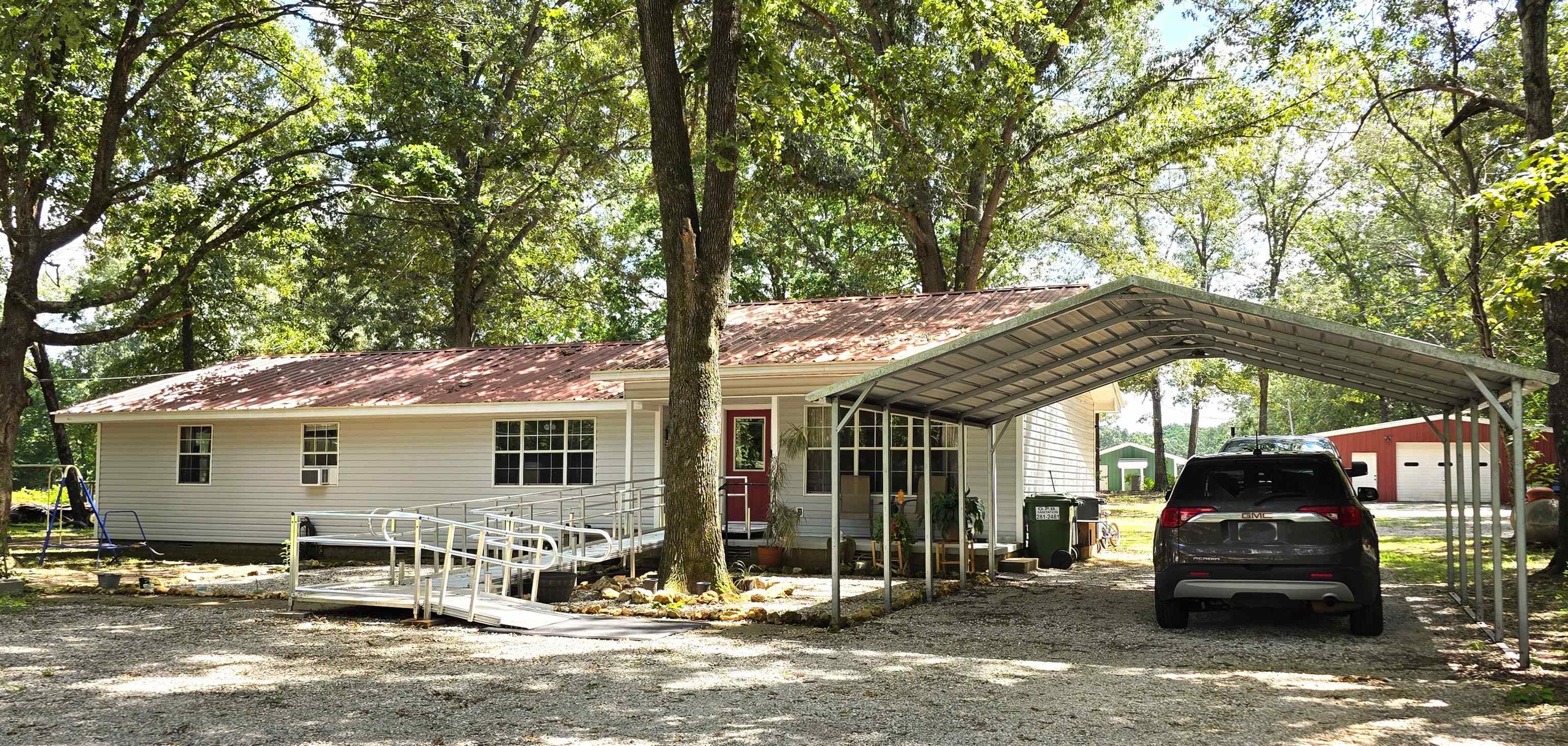 Discover a blend of comfort, space, and location with this inviting 3-bedroom, 2-bath home situated on nearly an acre. Inside, you'll find a spacious layout featuring walk-in closets that provide plenty of storage and convenience. Step outside to enjoy the 20' x 20' shop—ideal for hobbies, projects, extra storage, or a workshop.  You'll love being just minutes from the city park, the lively Music on the Square performances, unique shopping and dining, and the renowned Ozark Folk Center. With room to spread out, a convenient location, and the charm of small-town living, this property offers the best of both worlds. Don't miss the opportunity to make this property your own!