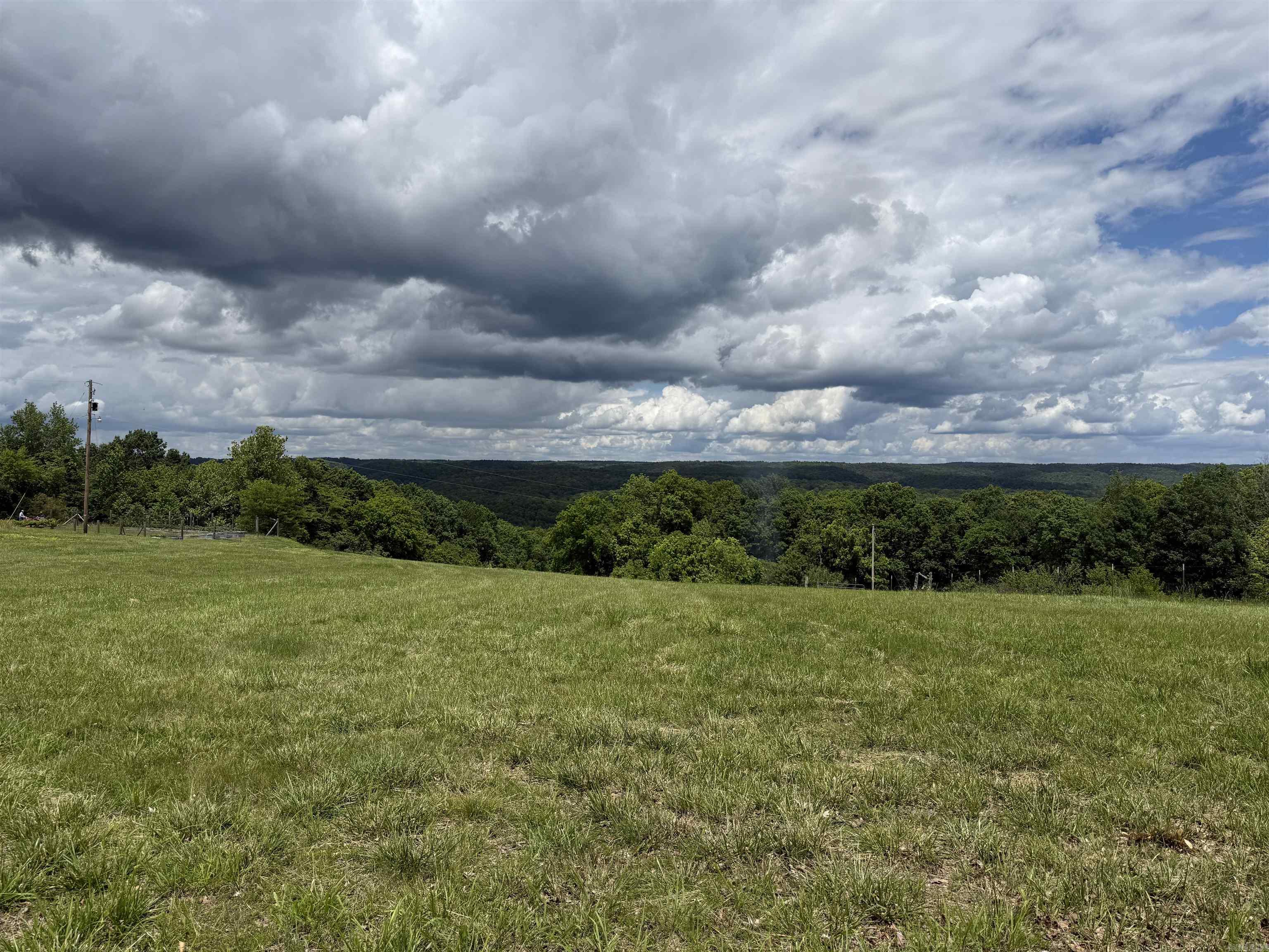 11.2 Acres m/l - Fully Equipped with Utilities, Barn & Mountain Views!  This stunning 11.2 acres m/l offers the perfect blend of open space, functionality and scenic beauty. With water, electricity, and a septic system already in place, it's ready for your dream home, hobby farm, or weekend retreat.  The land features a large barn, and is fenced - ideal for a few animals. Breathtaking mountain views create a peaceful picturesque setting that's hard to find. Whether you’re looking to build, or simply enjoy wide open spaces, this versatile property offers endless possibilities. Don't miss your chance to own this well - appointed property. THIS PROPERTY WILL HAVE DEED RESTRICTIONS