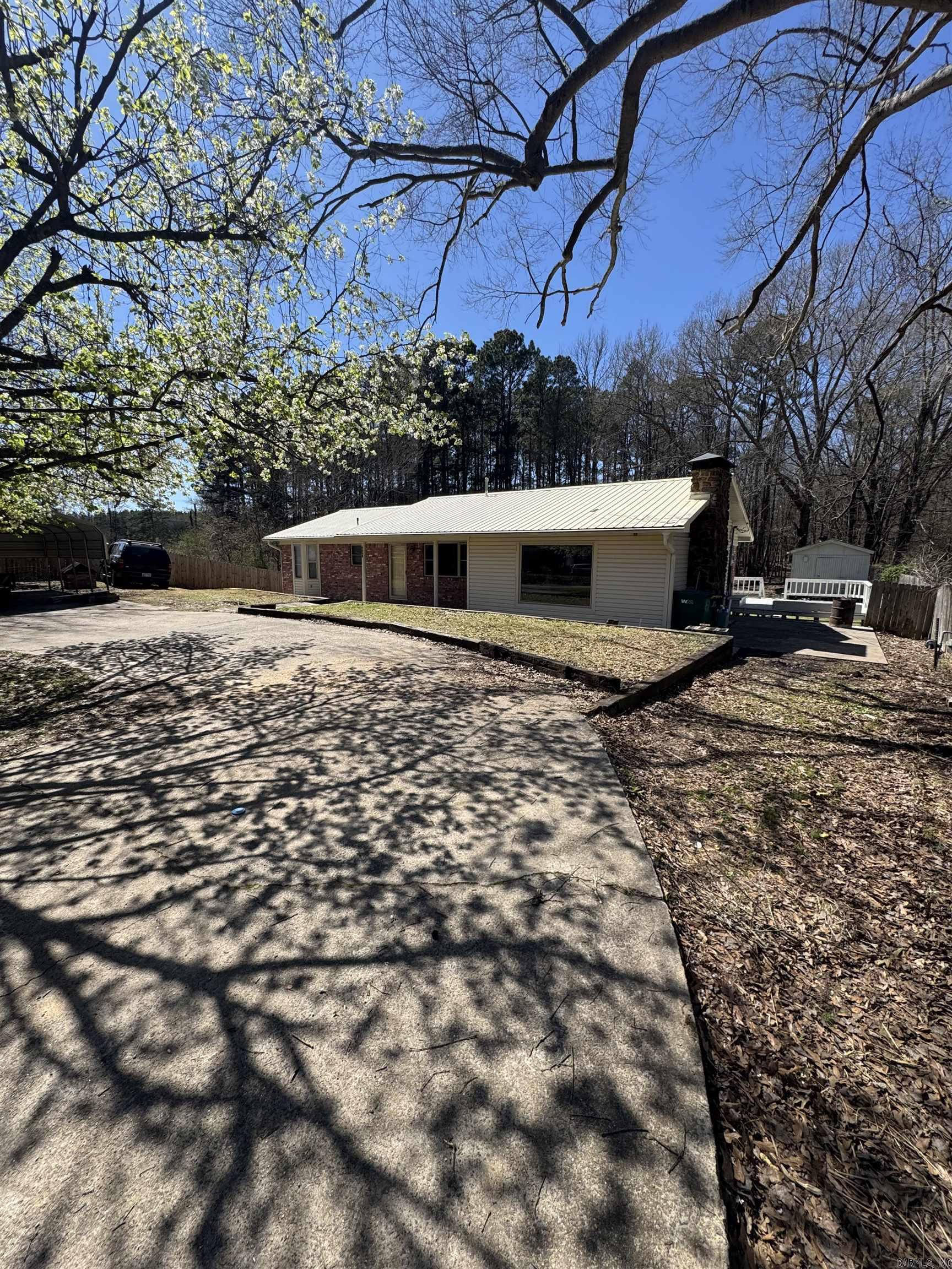 This newly remodeled 3-bedroom, 2-bathroom home is conveniently located just off I-530 in Hensley. It offers two spacious living areas, including a den/family room with a rock wood-burning fireplace, perfect for relaxing or entertaining. The kitchen has been updated with new countertops, flooring, lighting, and opening up the space into the den.  The home features fresh paint, new flooring, updated fixtures, and more throughout, giving it a modern and refreshed feel. Outside, you'll find a large, fenced-in backyard with a storage building, offering plenty of space for outdoor activities. The circle drive with a carport and metal roof adds convenience and durability.  This home is move-in ready with updates that make it feel brand new. See the associated documents for a full list of updates.
