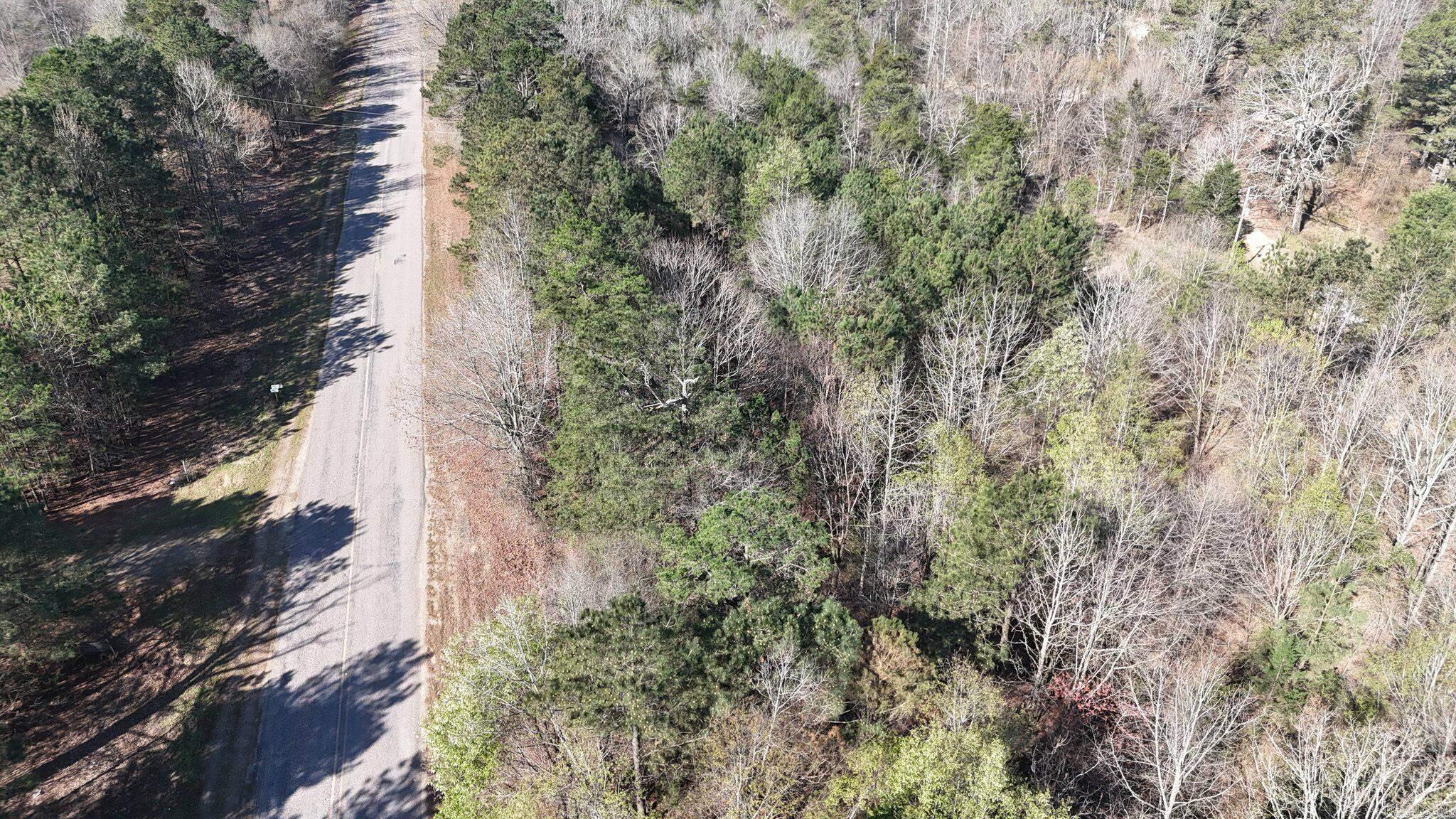 4.15 acres on the left side of Gillham Lake Road, just minutes from Gillham Lake and Cossatot Reefs. This unrestricted tract has power on site and easy road-front access, offering strong potential for RV sites, cabins, tiny homes, or boat/RV storage, subject to all applicable approvals. The gently rolling terrain and natural setting provide room to plan an RV or cabin setup, short-term rental concept, or a private retreat close to fishing, boating, hiking, and other area recreation. With no known subdivision or use restrictions, buyers can explore a variety of residential or recreational layouts consistent with local regulations. An additional 3.5 acres with RV sites is available on the opposite side of the road; see MLS #26008889.