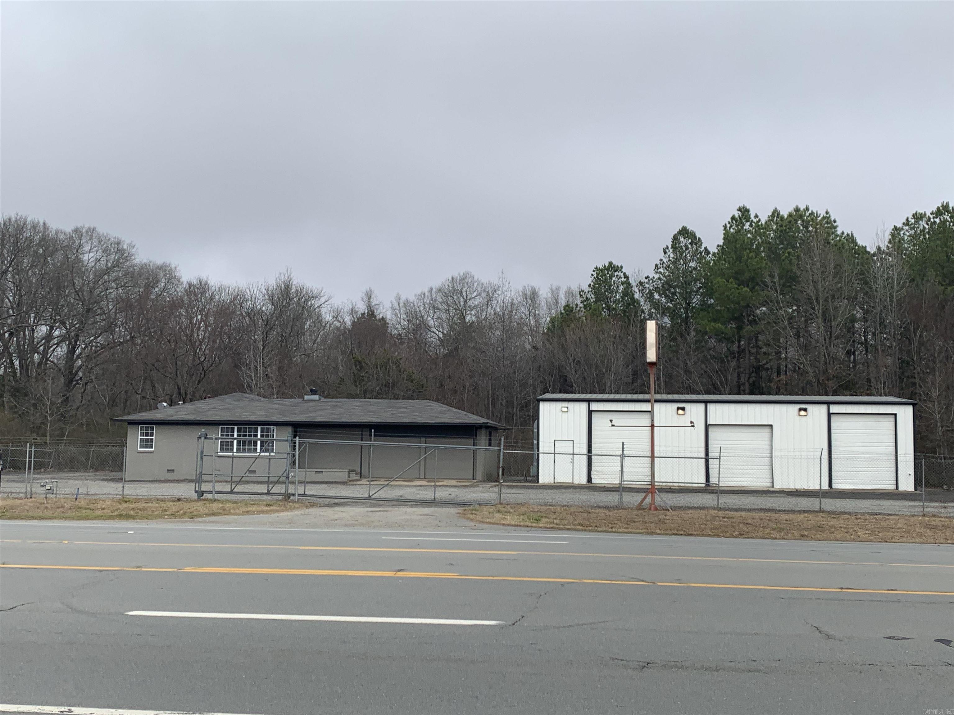 PROPERTY HIGHLIGHTS - LEASE SPACE AVAILABLE! - High Visibility. - Office has three private offices with a meeting room and entry. - Offices has new carpet and paint. - Additional two door storage faciality attached to the office. - Shop has bathroom and three large overhead doors. - Lot is fully fenced and entirely graveled. -Sliding front gate entry. -Large lot lights on building for ample illumination of lot.