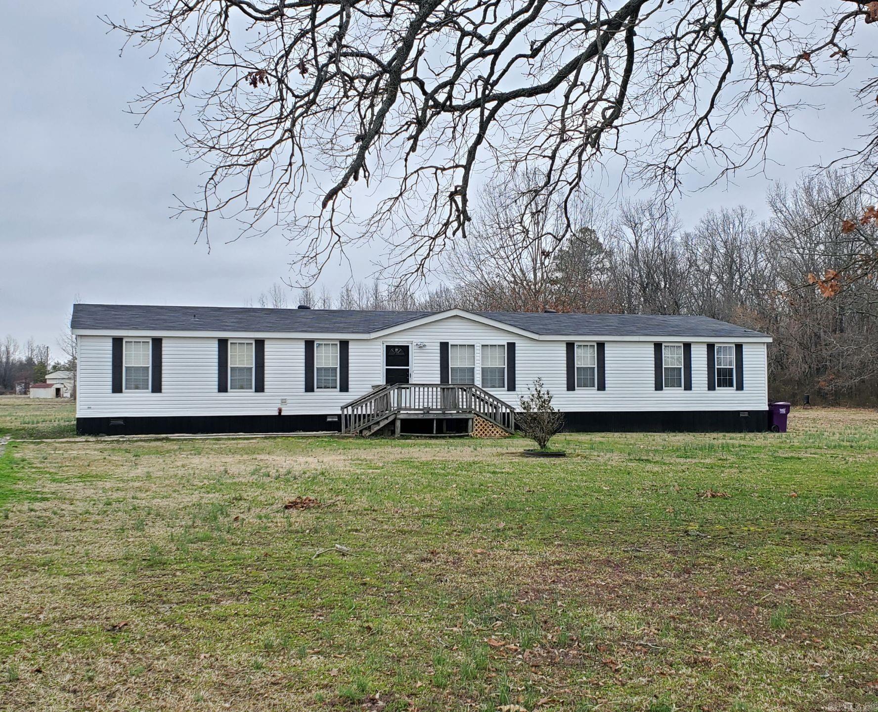 Well Maintained Large Manufactured home on 3+/- acres of cleared/level land, permanent foundation, Title to home has been canceled already turning it into real property.  Roof, HVAC, and metal skirting are less than 3 yrs old, New LVP Flooring thru-out home except Bedrooms was installed about 2 years ago. 4 Bedroom 2 bath, 2 Living areas, Large Awesome Kitchen that includes an Island, cook-top stove, Wall oven, 2 lazy susan's, pull out trash cabinet, and oversized Pot/pan drawers... The large laundry room has a huge Pantry Closet. Master bedroom has a large extra room attached, would make a great Nursery, office, etc..Year and half old 30 x 30 shop with 30 x 40 slab with 10 x 30 porch includes 2-10ft roll up doors and one walk through door . Bring your animals and/or off road toys and enjoy Country Living at it's Best. Call Today ~~Please see agent remarks