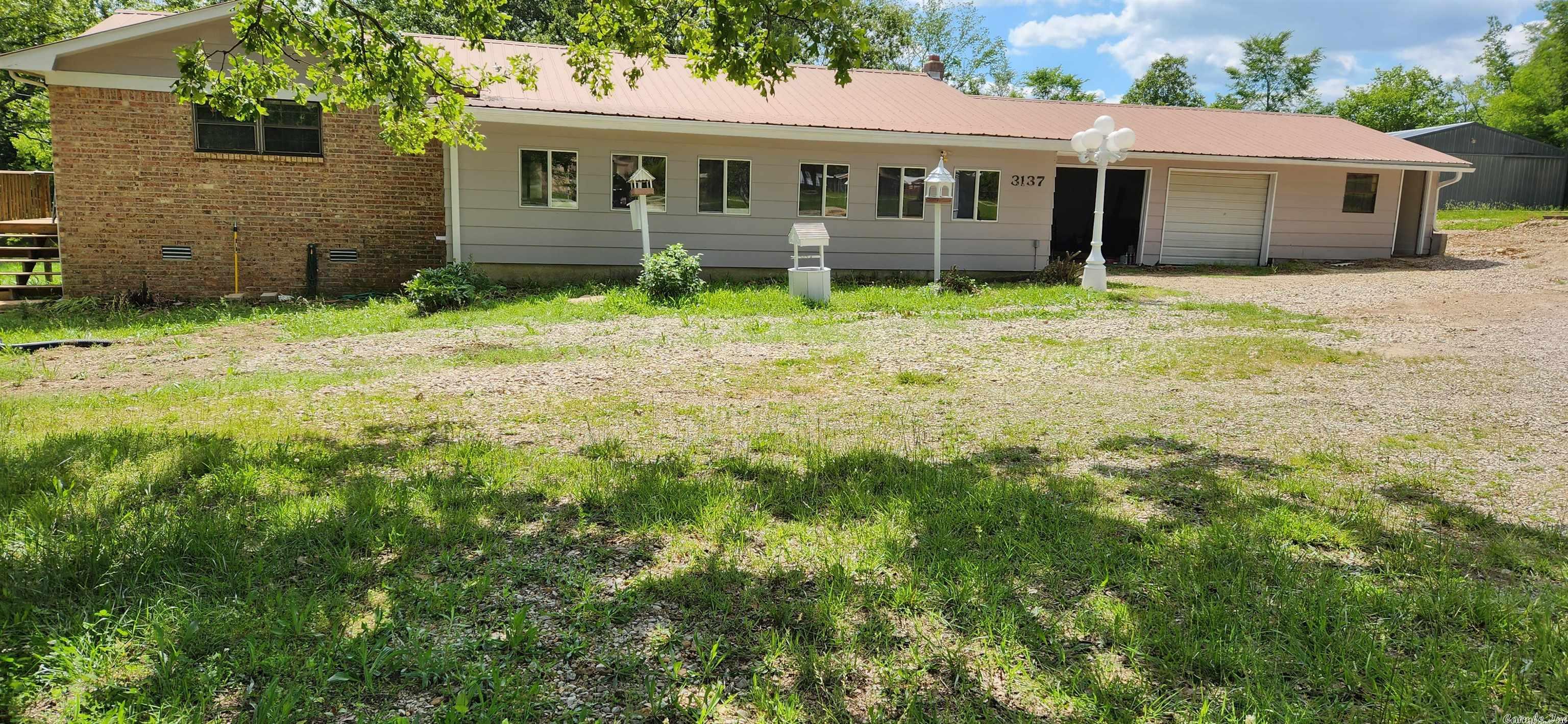 Great location with lots of space inside and out! This home has three bedrooms, two bathrooms, two-car garage with a separate room on the other side, and a large enclosed sunroom in front that could be made into two extra bedrooms - meaning six bedrooms are possible! Large open kitchen/living/dining/den area and there's room for a private office or bedroom. Several private entrances with private decks! The house sits on 2.85 acres with highway frontage and comes with a big 60x30 detached shop that has its own 3 phase box, concrete floor, large wood furnace heat, and plenty of outlets. There is also a nice pond, another pond behind the property, and a storage shed with 110 and 220 volts available throughout. 2 concrete pads for other buildings. State of the art NEXT fiber optic internet powered by NAEC available! NEXT offers up to 1Gbps broadband internet, telephone and television services to all subscribers. Also available at a lower price without the shop! See MLS #23037560. Owner financing possible at $194,000 with acceptable terms. Broker owned. Shown by appointment only, as is.