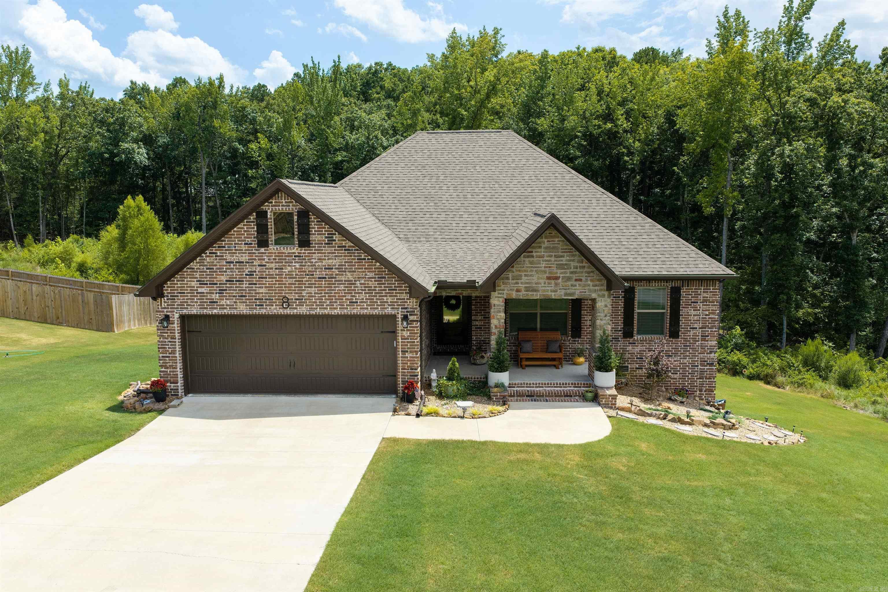 Absolutely spotless 4-bedroom home, built in 2023, located in Little Red River Estates Subdivision with a community dock on the Little Red River!  Open concept floorplan with tall ceilings, LVP flooring, quartz countertops, stainless appliances, built-in microwave, crown molding, kitchen island with breakfast bar, gas log fireplace, primary bedroom is separate from other bedrooms and has walk-in shower and separate tub, covered front porch and covered back deck, beautiful lawn, 2-car garage with safe room, brick exterior, wonderful landscaping, beautiful views of nature, sunsets and abundant wildlife...and much more!  You will not find a home that's been taken care of better than this one!!!