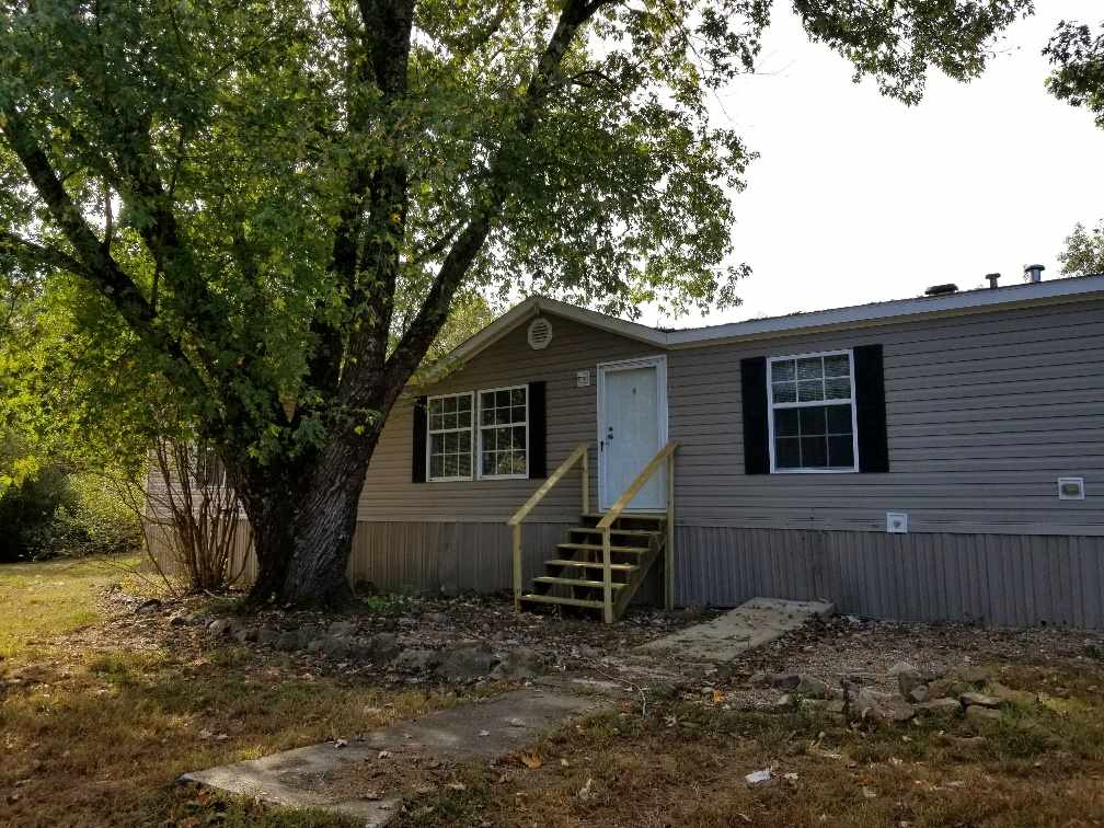 Spacious 4 bedroom, 2 bath manufactured home on 1 acre. This home includes a master suite with a sitting area, two living areas, 1 with a fireplace. The home recently had new flooring, paint, mini-blinds and front and back decks added.