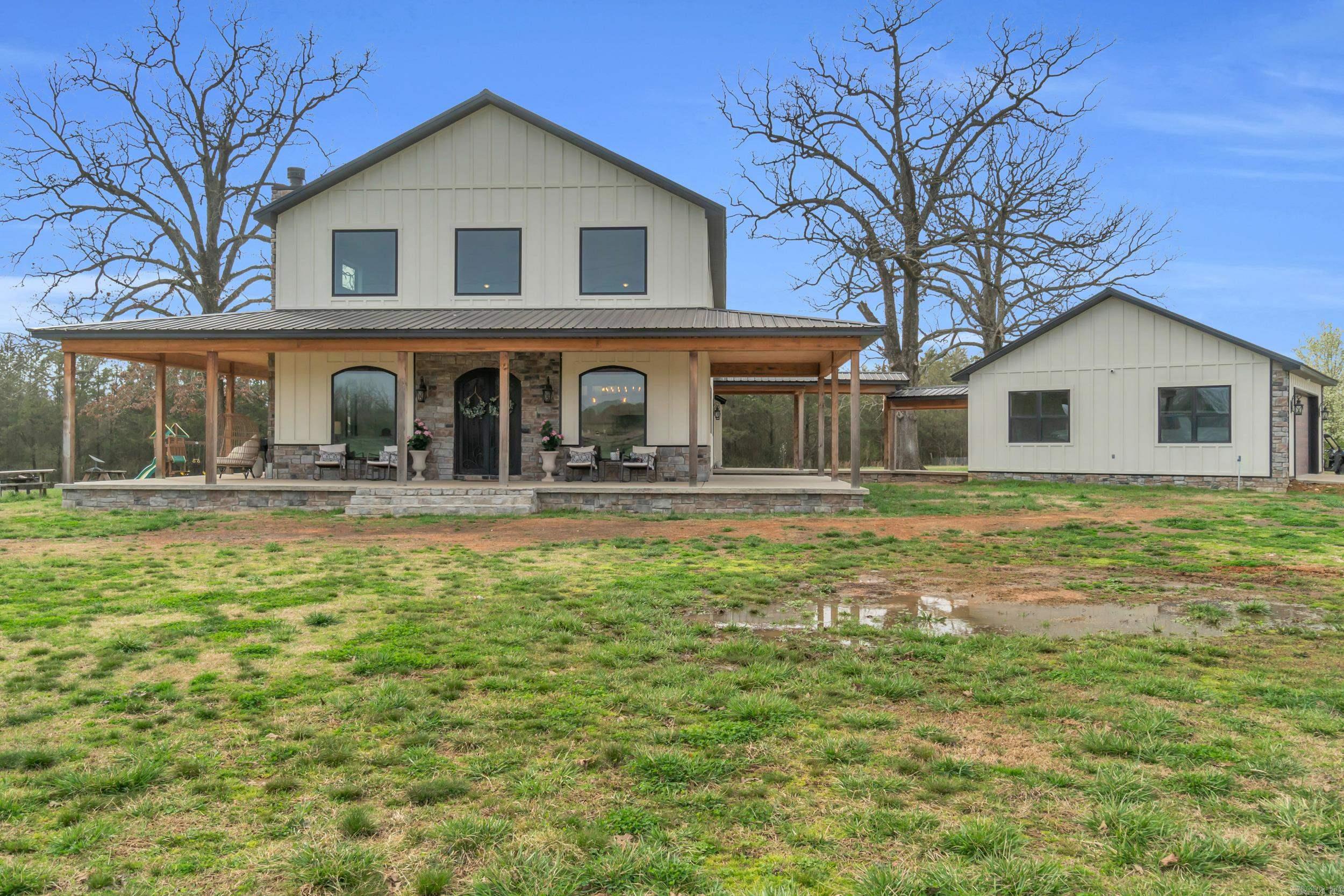 Welcome to this stunning 2-story home, built in 2022 and perfectly situated on +/- 5.22 acres of peaceful countryside. With a spacious wrap-around porch, 2-car detached garage, and a list of incredible features, this property truly has it all! Inside you'll find 4 bedrooms, 2.5 bathrooms, and an open-concept living space that's made for entertaining. The gourmet kitchen includes a walk-in pantry, high-end appliances, quartz-countertops, and custom cabinetry, while the oversized laundry room offer not one, but two washer/dryer sets. There's even a dedicated mud room and dog washroom to keep things clean and organized! Upstairs, the luxurious primary suite is a true retreat, featuring his and her vanities and closets, a soaking tub, loft area, and a cozy gas fireplace right in the bedroom. Outside, you'll find a hot tub, storm cellar, RV hook-ups, & breath-taking scenery. This property is outside of city limits, so bring your cows, horses, and chickens! Very close to public River access. 15-20 minutes to Searcy or Heber Springs. This home with acreage is available for purchase, with additional options to buy the pond and acreage or the shop and acreage separately. See agent remarks!