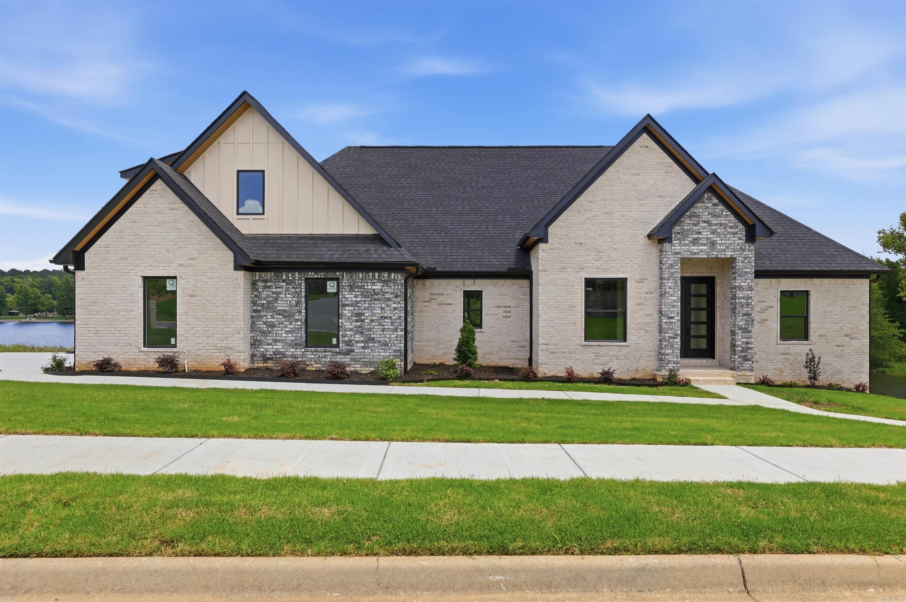 Luxury Lakefront New Construction in Hurricane Lake Estates   Welcome to 7612 Shoreline Blvd, Benton, AR—a beautiful new construction home situated on the lake in the highly desirable Hurricane Lake Estates.  Featuring 3 bedrooms, 3 bathrooms, and a bonus room that could easily serve as a 4th bedroom, this thoughtfully designed home offers the perfect blend of elegance, comfort, and functionality. The spacious open floor plan creates an inviting atmosphere, ideal for both everyday living and entertaining.  Direct lake access allows for boating, fishing, kayaking or just relaxing as the sun sets. The community offers pickleball & tennis courts, pool with kids’ splash pad, playgrounds, & scenic walking trails—designed for family-friendly living.  From the stunning curb appeal to the serene waterfront setting, every detail of this home has been crafted to provide a luxurious lifestyle. Enjoy peaceful lake views, modern finishes, and the beauty of living in this amazing community.  This is your opportunity to own a gorgeous waterfront home and enjoy lake living at its finest. Call today to reserve your very own personal showing.