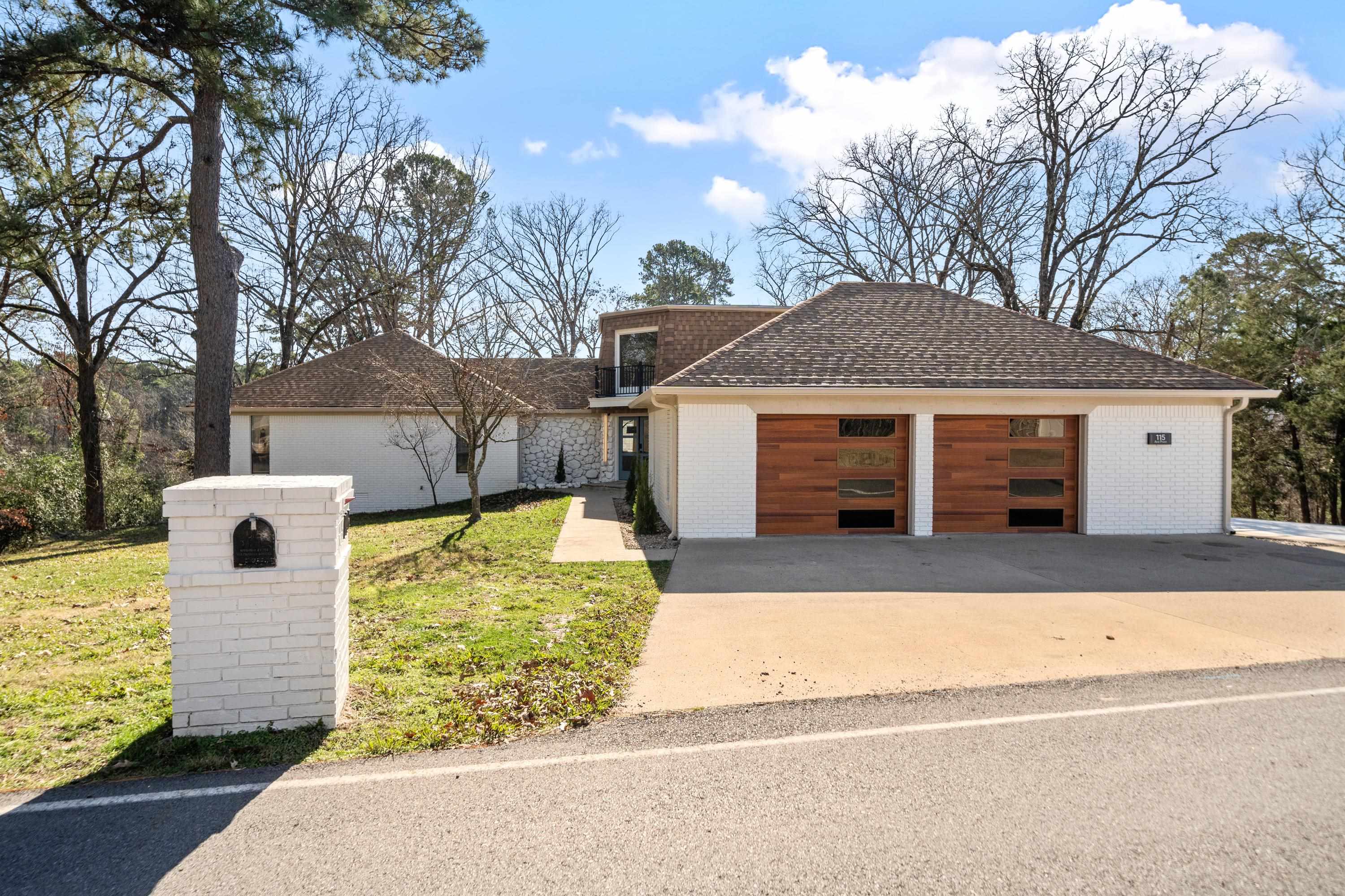 This tastefully updated Lake Hamilton home is nestled on over 1.7 waterfront acres. This is a rare find, offering the perfect combination of spacious land and lake-front recreation. Inside, the 4 bedroom, 4 bathroom home features stunning updates & finishes, including a gorgeous master suite with a huge walk-in closet, a soaker tub, and his/hers tiled showers. You'll love the main living area with a cozy electric fireplace and large windows that flood the home with natural light.  Downstairs, you'll find a spacious family room/man cave with a stone fireplace, 1 bedroom, a full bath and a beautiful built-in bar.  Step outside to an outdoor oasis with direct lake access, a charming gazebo covering the outdoor kitchen area, and over 1.5 acres of land. Don't miss this opportunity to own a truly exceptional Lake Hamilton property.
