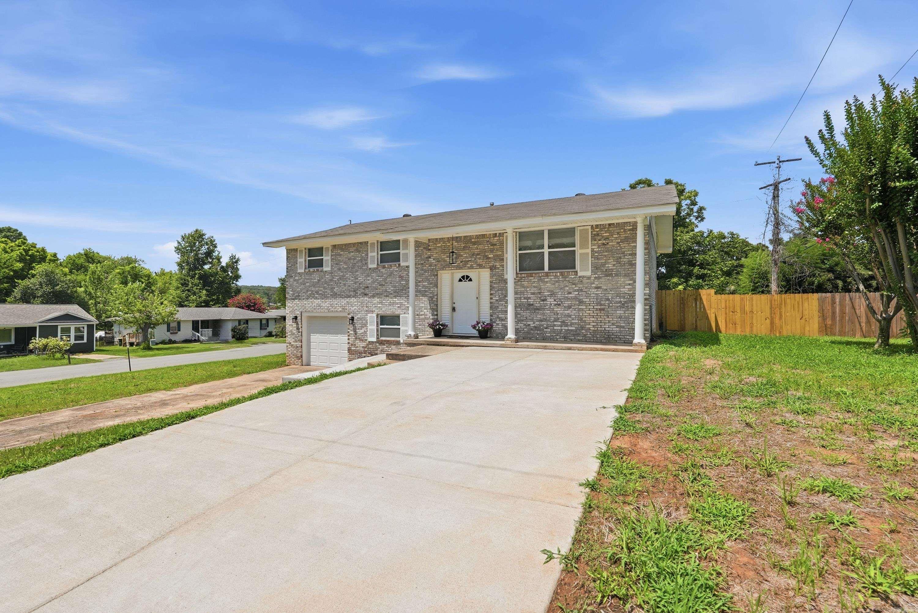 Completely remodeled from top to bottom, this stunning split-level home is truly move-in ready! The upper level features bright, open common living spaces, a beautifully updated kitchen with all-new cabinetry, countertops, and lighting, plus two fully remodeled bathrooms. Downstairs offers an additional bedroom, a third full bathroom, and an incredible bonus space perfect for a second living area, game room, home office, or gym. Enjoy brand-new flooring throughout the entire home along with new vanities, plumbing fixtures, lighting, and countless other upgrades—virtually everything is new! Step outside to the show-stopping brand new deck overlooking the freshly fenced backyard, creating the perfect space for relaxing or entertaining. Situated on a desirable corner lot, this home combines style and function in every detail. This is one you truly must see to appreciate!