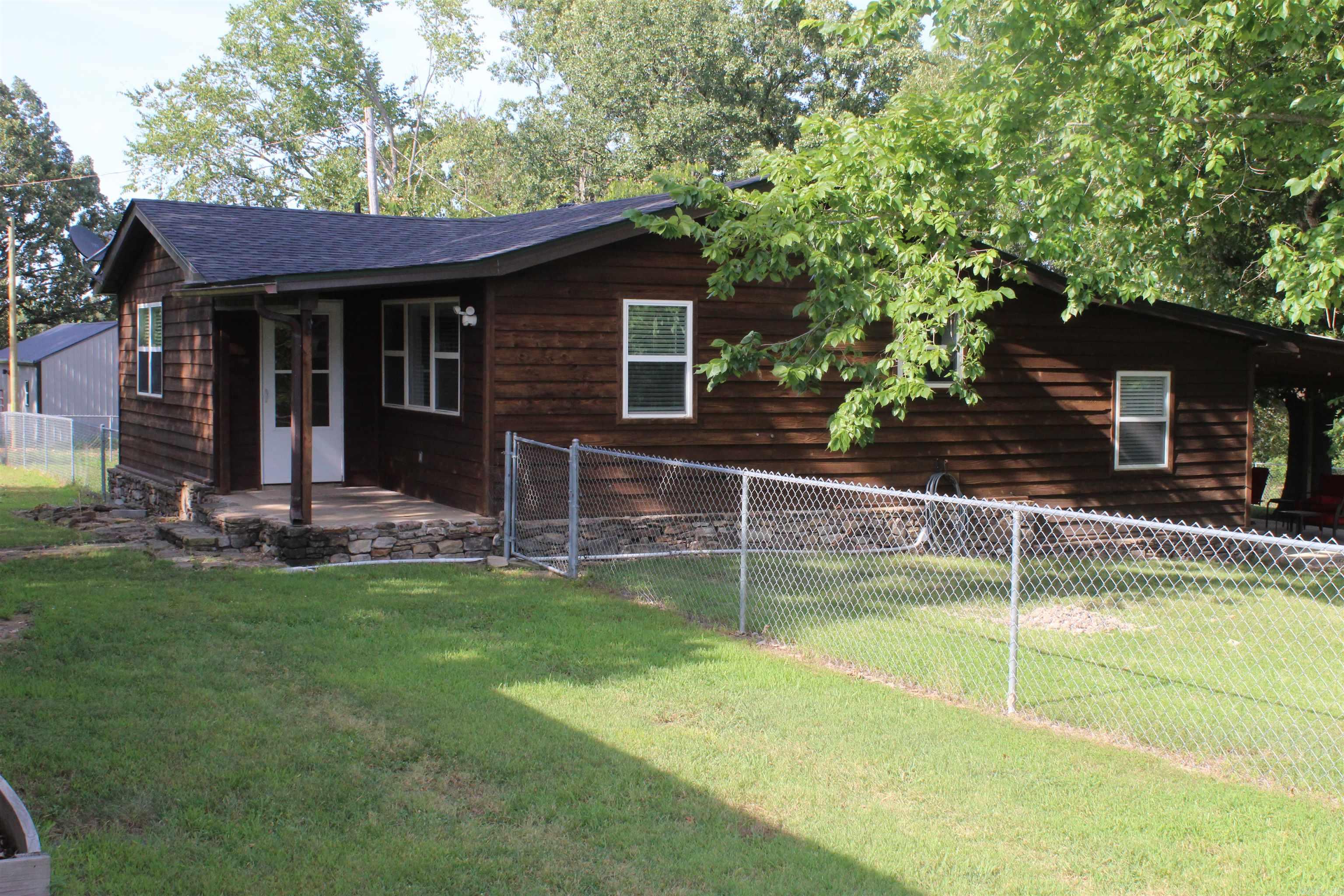 Ideal Getaway, Forever Home, or Airbnb! Remodeled, move-in-ready 3-bedroom, 2-bathroom home offers comfort, space, and outdoor enjoyment. With State Highway frontage for easy access, ideal as a full-time residence, weekend retreat, or short-term rental investment. Fiber internet  available, making it easy to stay connected for working remotely or streaming your favorite shows. Step inside to find a bright, updated interior, featuring a private primary suite complete with a walk-in shower and direct access to a spacious covered patio—perfect for grilling, relaxing, and watching the abundant l wildlife. The expansive yard offers plenty of space for gardening, and a chain-link fence around three sides provides a secure area for pets to roam. A detached 960 sq ft garage/shop offers versatile space for storage, hobbies, or a workshop. Enjoy the peace and quiet of the countryside with the convenience of being just 10 minutes from Marshall for daily essentials and dining. Branson, MO is just 1.5 hours away for shopping and entertainment. Only 20 minutes to the Buffalo National River where you can enjoy fishing, kayaking, canoeing, hiking, and numerous outdoor activities! Don't miss out!!