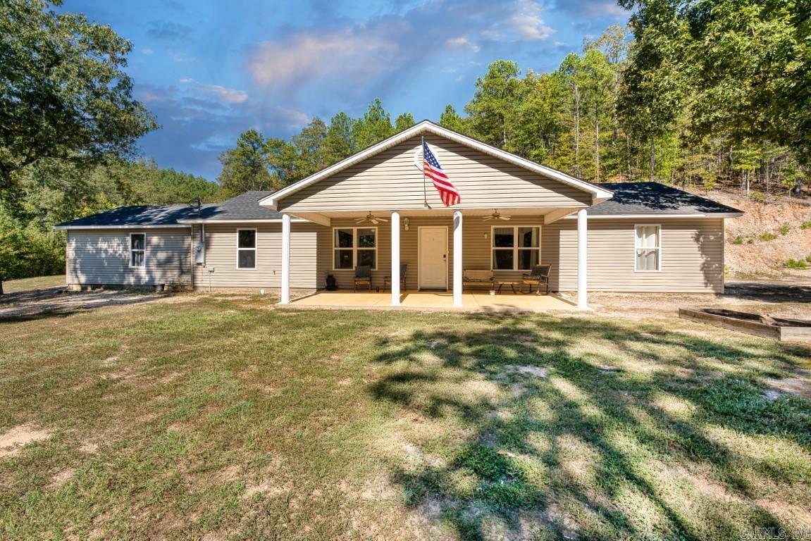 Welcome to your serene retreat in the heart of nature! This charming one-level home, nestled on 5.6 acres, offers the perfect blend of tranquility and accessibility. Located just a couple of miles from Lake Ouachita, this haven is a nature lover's dream, sitting against the National Forest on three sides.  Inside the home, you'll discover a spacious and inviting living space, complete with 3 cozy bedrooms, 2 well-appointed bathrooms, and a generous two-car garage. The open layout of the living areas allows for seamless flow and plenty of room for family gatherings and entertaining.  Whether you're an avid hiker, birdwatcher, or simply seeking a peaceful place to unwind, the expansive grounds offer endless possibilities. The proximity to Lake Ouachita, the Rabbit Trail Boat Ramp, and the Buckville Day Use area and beach make this location a water lover's paradise. Enjoy fishing, boating, picnics by the lake, and sandy beach days just moments from your doorstep.  If you're looking for a peaceful retreat that's also conveniently located near outdoor recreational opportunities, this 3-bedroom, 2-bathroom home on 5.6 acres is the perfect place to call your own.