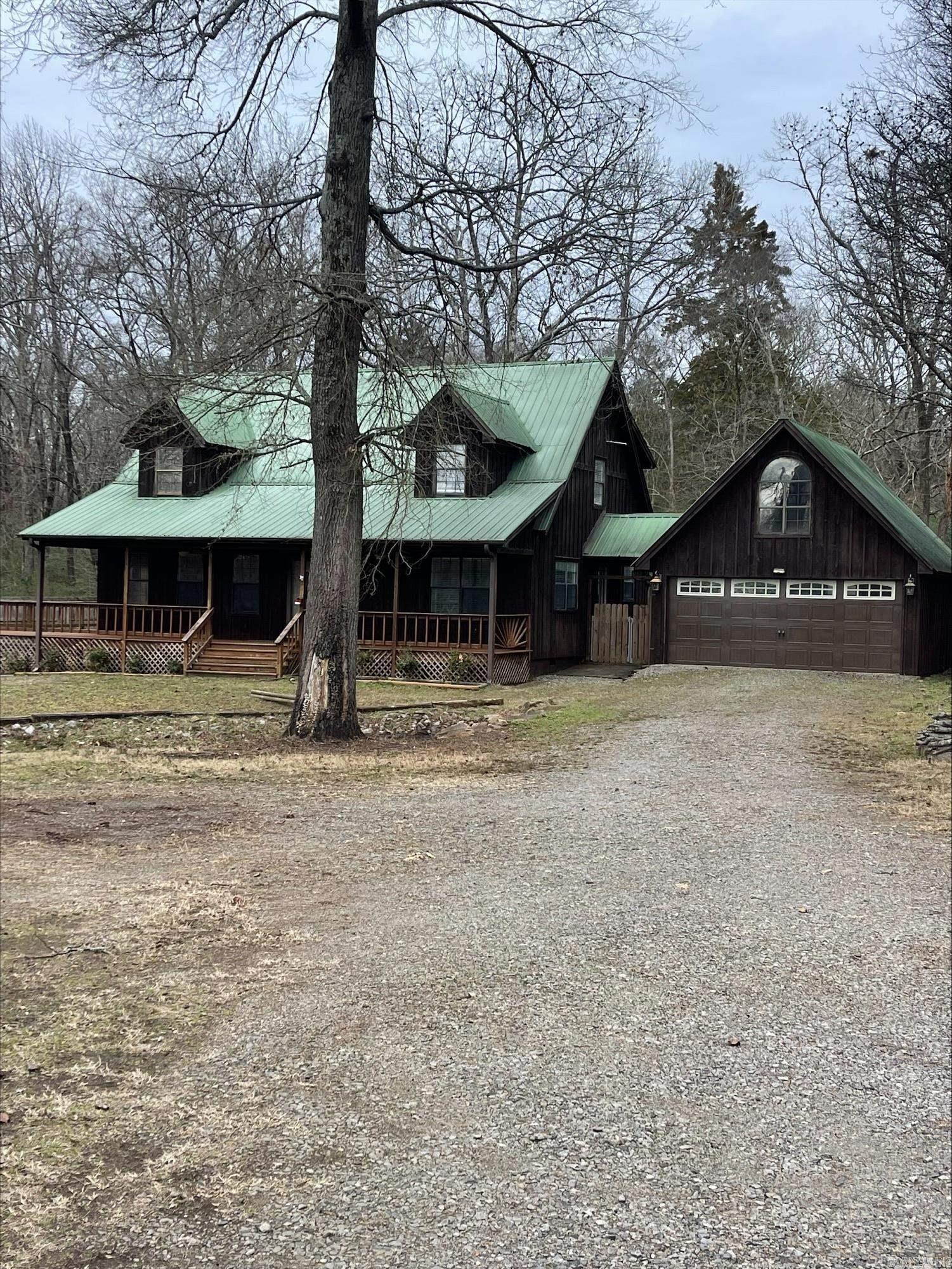 Cedar home with metal roof and large oversized garage +1200 Sq Ft shop, wrap-around porch/deck, master has access to the upper deck. Beautiful location, minutes to interstate & downtown Searcy. Huge master bedroom/bathroom and enormous walk-in closet. Formal dining room, laundry room with a sink. The second upstairs bedroom has its own 1/2 bath. Beautiful home, must see to appreciate all it offers. Downstairs HVAC is brand new.