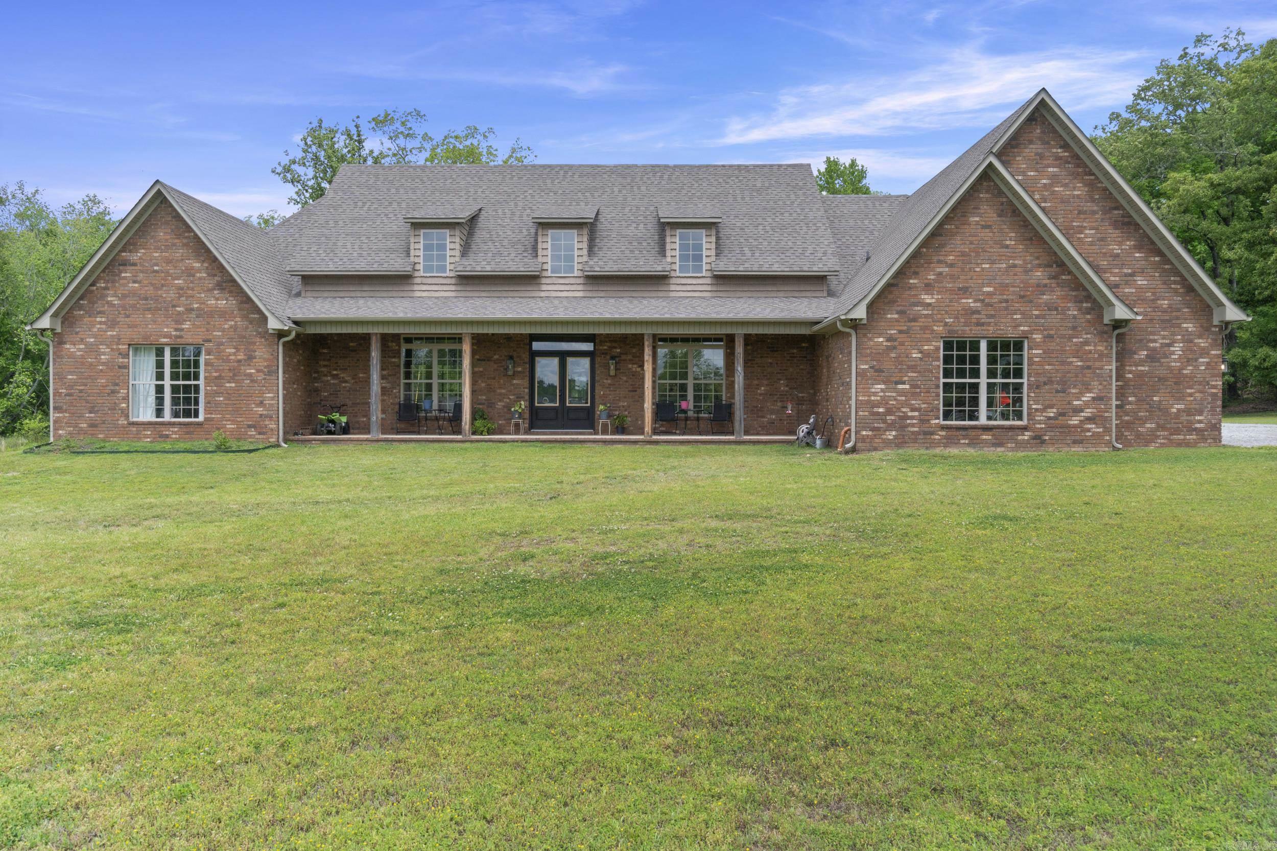 Large Price Reduction! Exclusive access to a stunning 38-acre lake and 80+ acres of scenic land! This one-of-a-kind custom home in Hunters Rest, built in 2021, sits on the canal with gorgeous lake views and direct access—just minutes from city amenities. Offering 4–5 bedrooms and 4.5 baths, the home features a grand open floor plan with soaring ceilings, a spacious family room with brick gas log fireplace, and a formal dining area. The custom eat-in kitchen includes marble countertops, shaker cabinets, a 36" gas range, double ovens, and a walk-in pantry. The primary suite boasts private screened porch access and a spa-like bath with freestanding tub, tiled shower, double vanities, and a large closet connected to the laundry room. Three guest rooms are on the main level, one with ensuite bath. Upstairs offers a bonus room with full bath and ample storage. Complete with a 3-car garage, powder room, and front porch with lake views—this is a rare find!