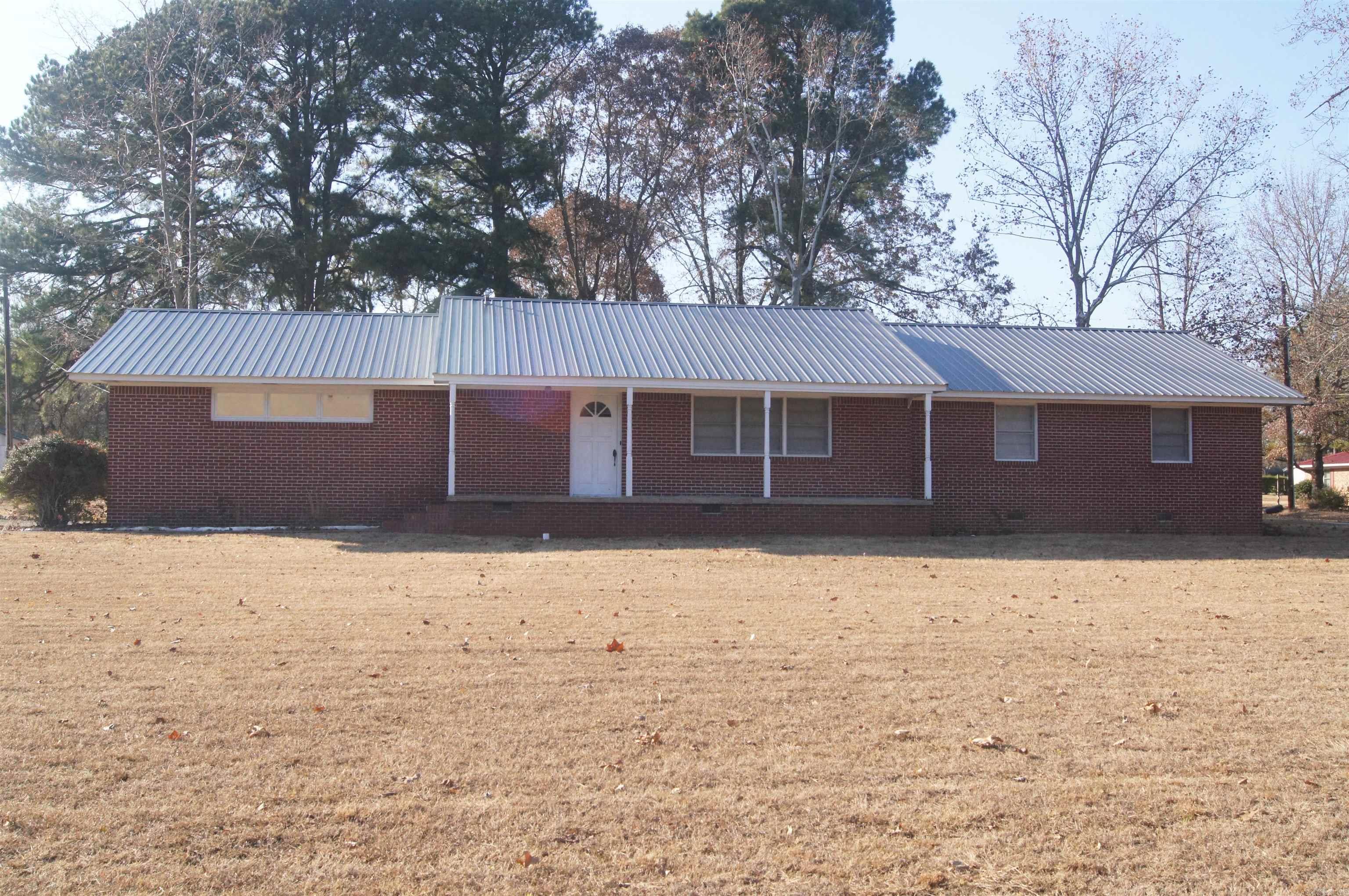 Nice larger older brick home with 2 car carport (that could be turned into a garage), 3 bedrooms, 2 baths, some updates been done, large living area and bedrooms, dining room, hardwood floors, no carpet all sitting on a 1 acre corner lot.  Knotty pine in kitchen.  Pictures were prior to rental but still looks the same.