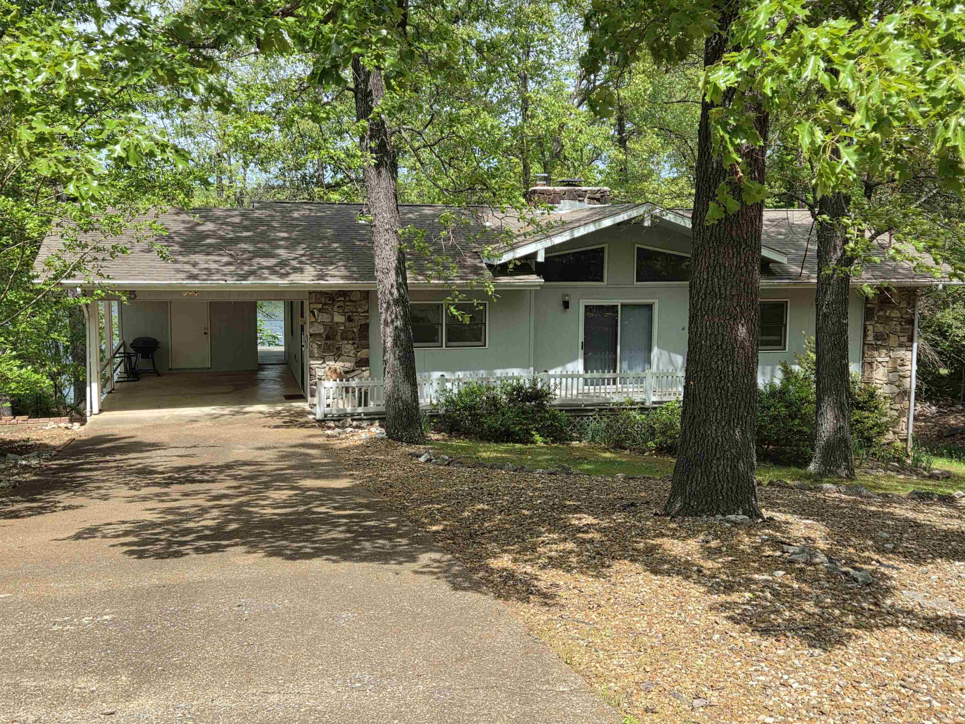 Privacy and Lakefront living, what more could you ask for? Deck expands the length of the back of the home and can be accessed from 2 bedrooms, living room and carport. The lower level has been updated with tile flooring, bathroom has a large walk-in shower. 2 kitchens, one on each level, both having dw, stove, fridge. Seller added two sun rooms to the lower level for more options of viewing the lake. Main level has three bedrooms, 2 baths, open living-dining area with 2 sided fireplace in the middle. Large Picture windows and vaulted ceilings let in tons of natural light. Carport with storage plus large storage room underneath for all your lake toys and yard tools. There is a vacant lot on both sides of the home for privacy & the land sits on the edge of a cove. All electric home w/wood burning fireplace and wood burning stove for back up. NAEC electric service also has an option for NEXT fiber optic internet service. Can be purchased furnished. See virtual tour