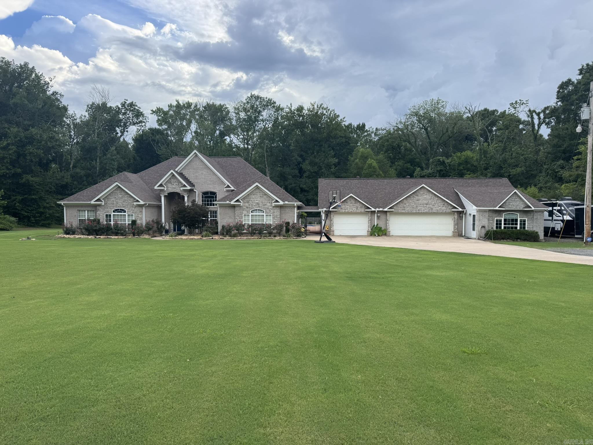 Welcome to this exceptional custom home offering 4,314 sq ft of versatile living space on a level lot just minutes from Hwy. 64 in Conway. The 3,554 sqft main residence features 4 bedrooms, 2 baths, a dedicated home office, spacious living areas, and a media room complete with a high-definition projector, projection screen, and surround sound system.   Perfect for multi-generational living, the property also includes two private 380 sq ft guest suites, each with a full bath and kitchenette. Step outside to your own backyard retreat featuring an in-ground swimming pool, pool bath, tiki bar, and plenty of space for entertaining family and friends.   Additional highlights include a 3-car garage, whole-home generator serving the main residence, solar system installed in 2022, a new roof installed in 2023, and an RV parking pad with a 50 amp outlet.   With its flexible floor plan, private guest accommodations, exceptional outdoor living, and premium amenities, this one-of-a-kind property offers a lifestyle rarely found in today's market.