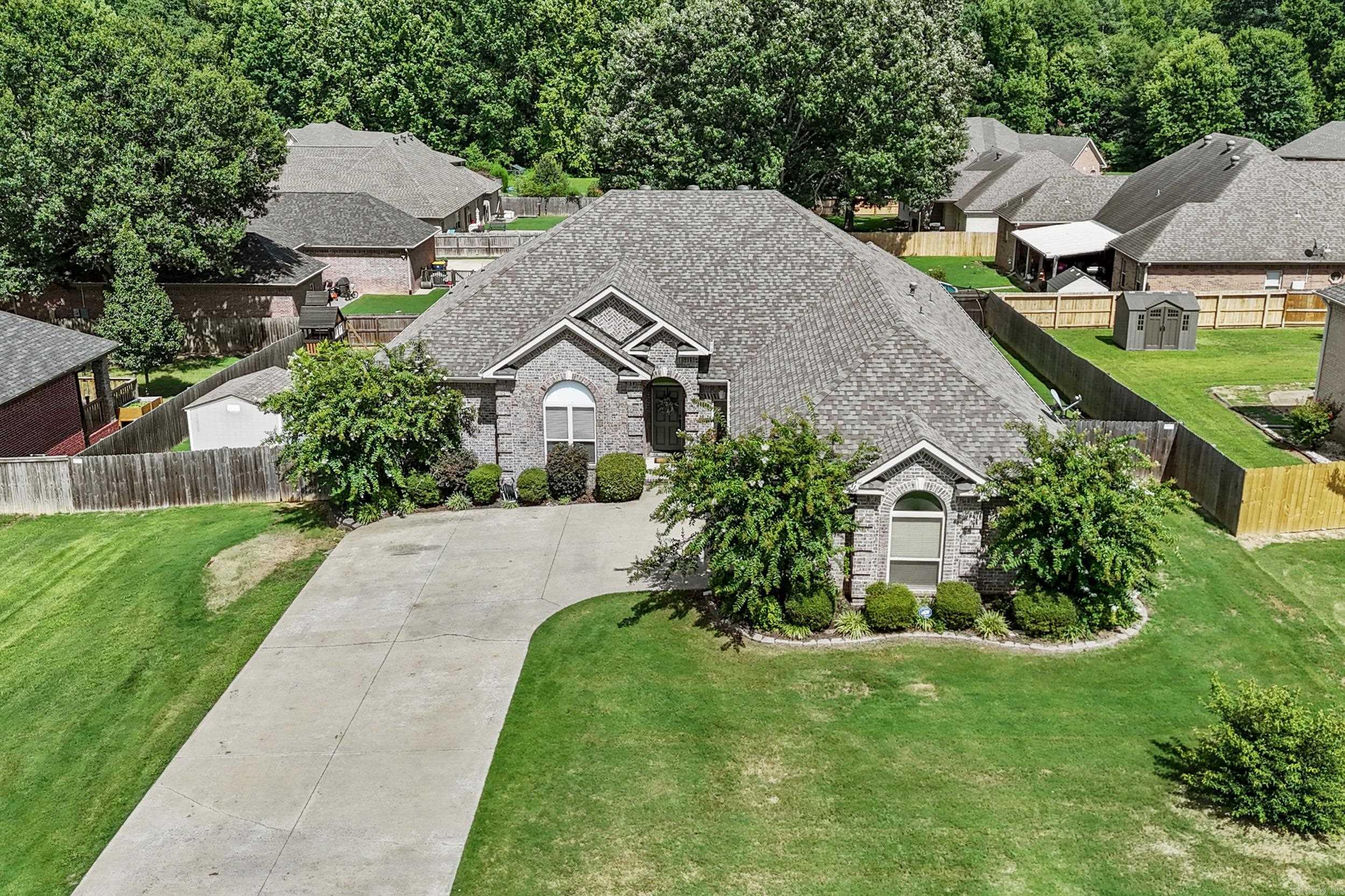 One of the nicest homes in prestigious Shiloh Subdivision! This beautifully maintained 2,707 SF home offers 4 bedrooms, 3 full baths, 2 living areas, and a fantastic split floor plan. The private 4th bedroom and bath are ideal for guests or in-law quarters. Rich trim work throughout adds elegance. The formal living room features hardwood floors, a gas log fireplace, and a wall of windows, while the second living area opens to the spacious kitchen with a tray ceiling and hardwood floors. The kitchen offers a downdraft cooktop, convection wall oven, oversized breakfast bar, huge pantry, abundant cabinetry, and generous counter space. The primary suite includes separate vanities, a corner soaking tub, walk-in shower, and large walk-in closet. Enjoy the covered back porch overlooking the privacy-fenced backyard. Storage building stays. Oversized side-load garage with new mini-split HVAC. Roof and fence replaced in 2022, HVAC in 2019. Many updates and improvements in the past year include smart water heater, dishwasher, faucets, cabinet hardware, light fixtures, ceiling fans, fresh paint, water softener with reverse osmosis at kitchen sink, 10-person storm shelter, and generator hookup.