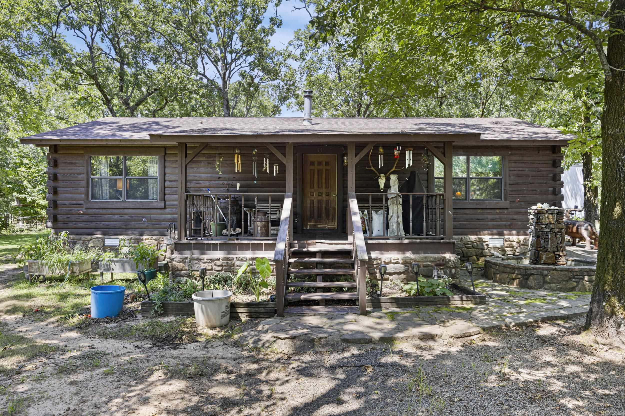 Beautiful Log Home sitting on 24.5 acres, detached log garage/workshop 12X24, and a large metal shop 40X30 — all tucked away on a private drive that feels secluded yet is just minutes from town. The home features an open floor plan, granite kitchen, pellet stove, hot tub, pool and fountain with fencing around the location. The views at this location sell themselves along with the wildlife pond, food plots, ATV trails, and abundant wildlife make this a hunter's dream.