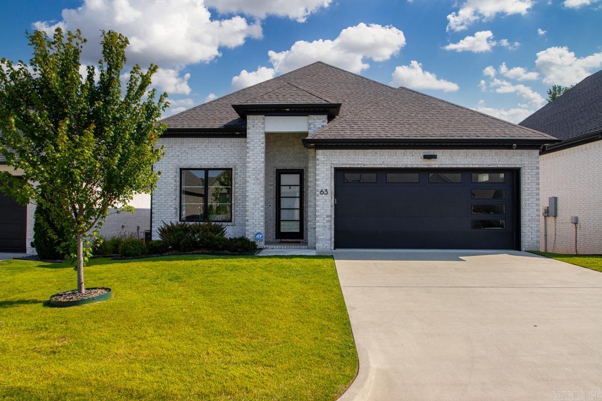 Immaculate one -level brick home in West Little Rock's desirable Parkside subdivision! This open layout features a gourmet kitchen as the true centerpiece, showcasing navy blue cabinetry, breakfast bar, quartz counters, gas cooktop, convection oven, walk-in pantry, and butler's area that flows to dining room. The main living space offers an electric fireplace and modern fixtures. Retreat to the private primary suite with a soaker tub, tiled shower, and custom walk-in closet. Two additional guest suites are split from the primary bedroom for maximum privacy. Laundry room with sink (washer and dryer conveys). Relax on the covered back patio backing up to a protected green space. HOA covers lawn care for a low-maintenance lifestyle. Minutes from premier shopping/dining at The Promenade at Chenal and Costco.