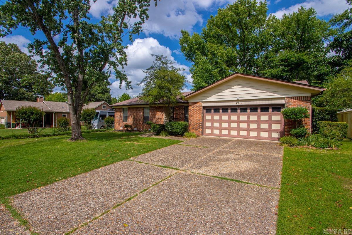 Welcome to this charming three bedroom two bath residential opportunity located in the heart of Sherwood, Arkansas. This home provides a wonderful canvas for buyers looking to add personal touches or updates to a classic layout. The entry introduces a welcoming foyer that connects to a formal living room, offering an excellent space for hosting guests or creating a quiet sitting area. The main hallway flows smoothly into the heart of the home, which highlights a spacious kitchen equipped with extensive wood cabinetry, generous counter space, and a dedicated breakfast nook framed by classic wood wainscoting. Relax in the expansive main living room, which includes a vaulted ceiling highlighted by exposed dark wood beams and a classic brick fireplace perfect for cozy evenings. The primary suite and secondary bedrooms offer comfortable dimensions, neutral paint tones, and ample closet space. Step outside to enjoy outdoor living in the large, screened-in back porch that overlooks a fully fenced, level backyard with mature trees. This property is ideal for anyone seeking solid bones, functional space, and a fantastic location. Square Foot Approximate Please measure.