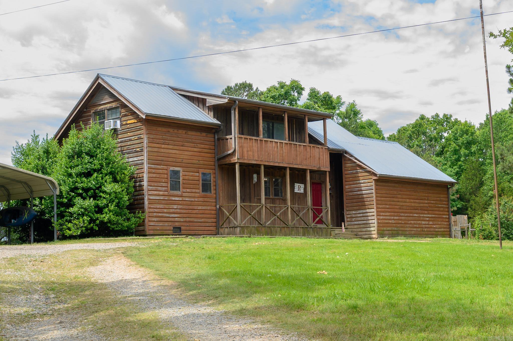 This beautiful log siding home offers the peace and privacy of country living with 18.94 acres of mostly wooded land to enjoy. Featuring 4 bedrooms and 2 bathrooms, this property provides the perfect balance of comfort and seclusion while being surrounded by the beauty of nature. Step onto the peaceful back porch and take in the quiet setting, the sounds of nature, and the relaxing views that make this property feel like a retreat. Upstairs, the private balcony offers another place to unwind and enjoy the scenery. Take a hike down the valley to enjoy the peaceful creek and remote wilderness. Adding even more charm, a creek flows through the backyard, creating a tranquil setting and enhancing the natural beauty of the property. With plenty of room to explore, enjoy wildlife, and appreciate the outdoors, this property offers endless possibilities for anyone looking for space, privacy, and a slower pace of life in a beautiful setting.