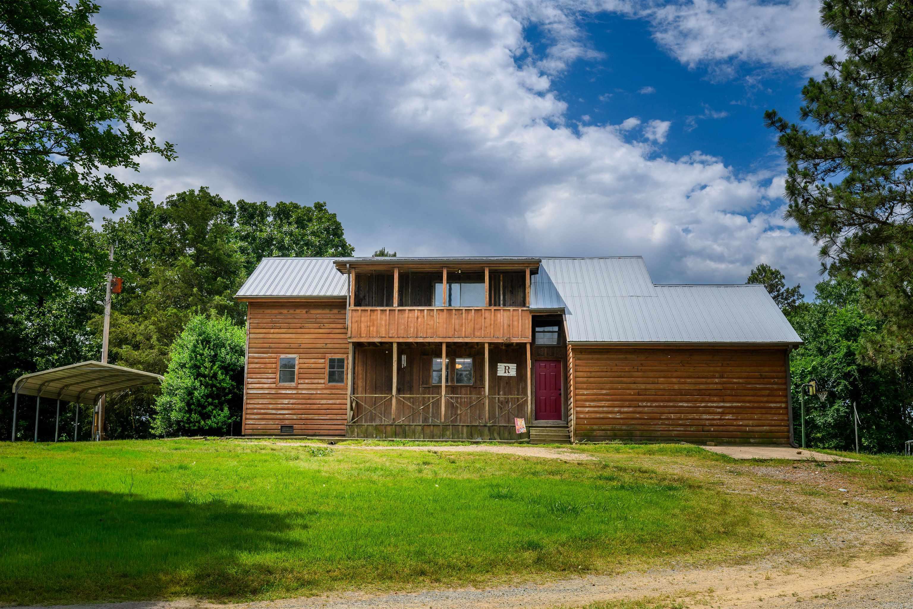 This beautiful log siding home offers the peace and privacy of country living with 18.94 acres of mostly wooded land to enjoy. Featuring 4 bedrooms and 2 bathrooms, this property provides the perfect balance of comfort and seclusion while being surrounded by the beauty of nature. Step onto the peaceful back porch and take in the quiet setting, the sounds of nature, and the relaxing views that make this property feel like a retreat. Upstairs, the private balcony offers another place to unwind and enjoy the scenery. Adding even more charm, a creek flows through the backyard, creating a tranquil setting and enhancing the natural beauty of the property. With plenty of room to explore, enjoy wildlife, and appreciate the outdoors, this property offers endless possibilities for anyone looking for space, privacy, and a slower pace of life in a beautiful setting.