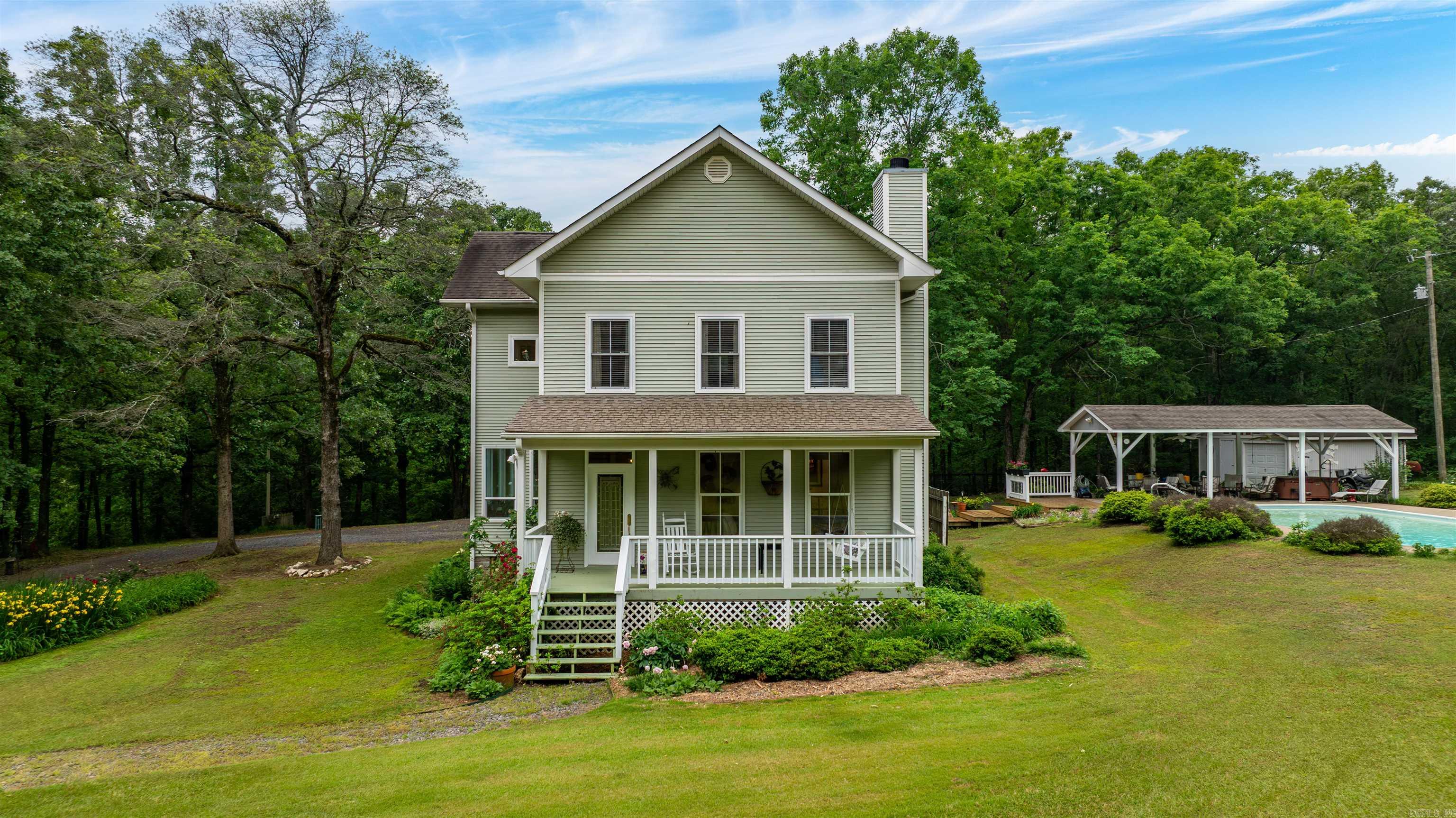 Beautiful 3 bedroom 2 1/2 bath home situated on 22+ acres with a stocked pond, saltwater pool and breathtaking views throughout the property! The main level features a nice den with built-ins on either side of the gas log fireplace, spacious dining area open to kitchen and den, an updated kitchen with quartz countertops and stainless appliances, cozy breakfast nook, a fabulous sunroom and half bath. Upstairs offers a spacious primary suite with ensuite bath and large closet, two additional bedrooms, a full bath and laundry room with sink. The stunning property includes both cleared and wooded acreage, beautiful landscaping, detached one-car garage, gazebo, pole barn, new luxury vinyl plank floors, fresh paint, tons of natural light, a dog run and more! Exceptional opportunity to have your own private retreat! See agent remarks.  Check out the video here: https://www.youtube.com/watch?v=d2kJuS-Bv2Y