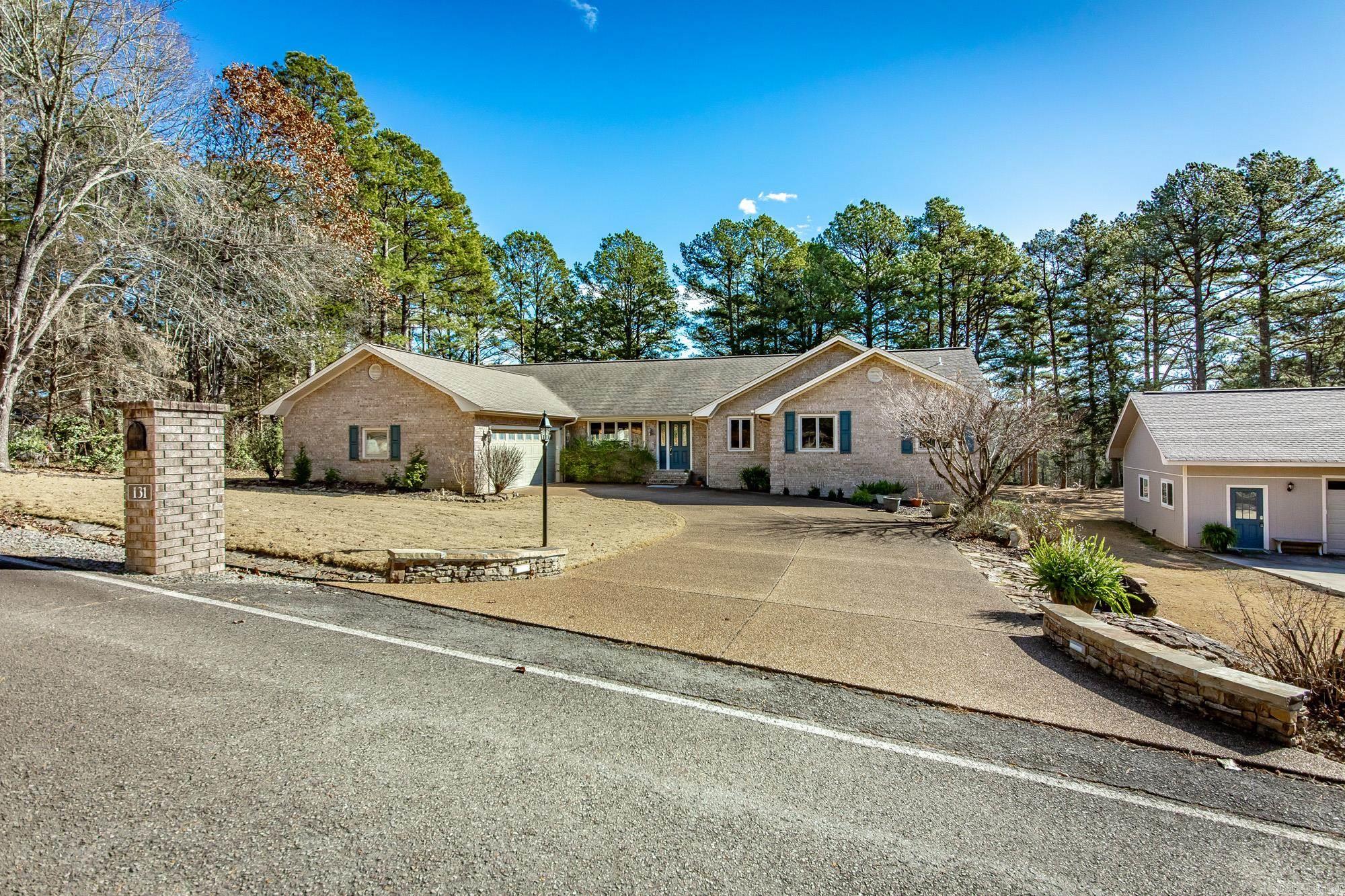 Welcome to effortless living on the 11th green of Mountain Ranch Golf Course! This beautiful one-level, all brick home offers the perfect blend of comfort, style, & low-maintenance—ideal for full-time living, or a second home near the lake. Inside, you’ll love the open, sprawling floorplan featuring gorgeous wood flooring, fresh paint throughout, new appliances, & stunning quartz countertops. The inviting living area is anchored by a beautiful stone fireplace, creating a warm & welcoming space for relaxing or entertaining. A den and separate office provide plenty of flexibility for guests, hobbies, or working from home. The oversized primary suite is a true retreat. Step into the screened-in room, overlooking the golf course offering the perfect spot to unwind after a day on the course or at the lake. Outside, you’ll find exceptional extras including a 24’ x 36’ detached garage with heat & air, a half bath, that is fully insulated and finished--ideal for a workshop, storage, or recreational space. There’s also a detached carport plus an RV hookup with electric, water, and sewer. This home has been meticulously maintained & comes mostly furnished.  Come enjoy golf course living.