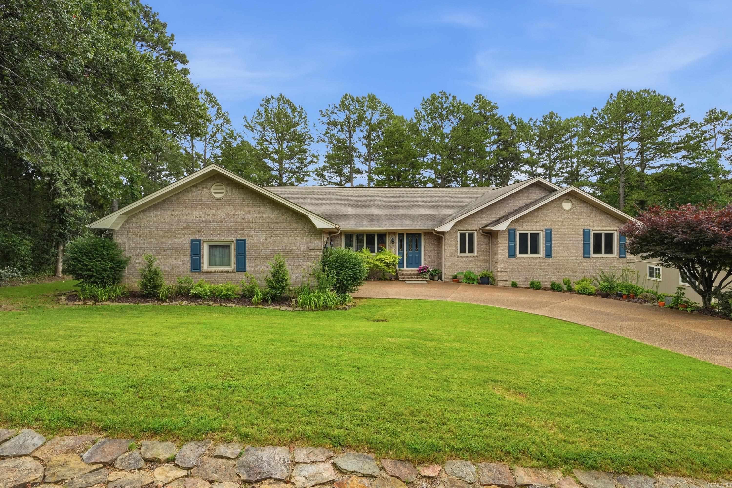 Welcome to effortless living on the 11th green of Mountain Ranch Golf Course! This beautiful one-level, all brick home offers the perfect blend of comfort, style, & low-maintenance—ideal for full-time living, or a second home near the lake. Inside, you’ll love the open, sprawling floorplan featuring gorgeous wood flooring, fresh paint throughout, new appliances, & stunning quartz countertops. The inviting living area is anchored by a beautiful stone fireplace, creating a warm & welcoming space for relaxing or entertaining. A den and separate office provide plenty of flexibility for guests, hobbies, or working from home. The oversized primary suite is a true retreat. Step into the screened-in room, overlooking the golf course offering the perfect spot to unwind after a day on the course or at the lake. Outside, you’ll find exceptional extras including a 24’ x 36’ detached garage with heat & air, a half bath, that is fully insulated and finished--ideal for a workshop, storage, or recreational space. There’s also a detached carport plus an RV hookup with electric, water, and sewer. This home has been meticulously maintained & comes mostly furnished.  Come enjoy golf course living.