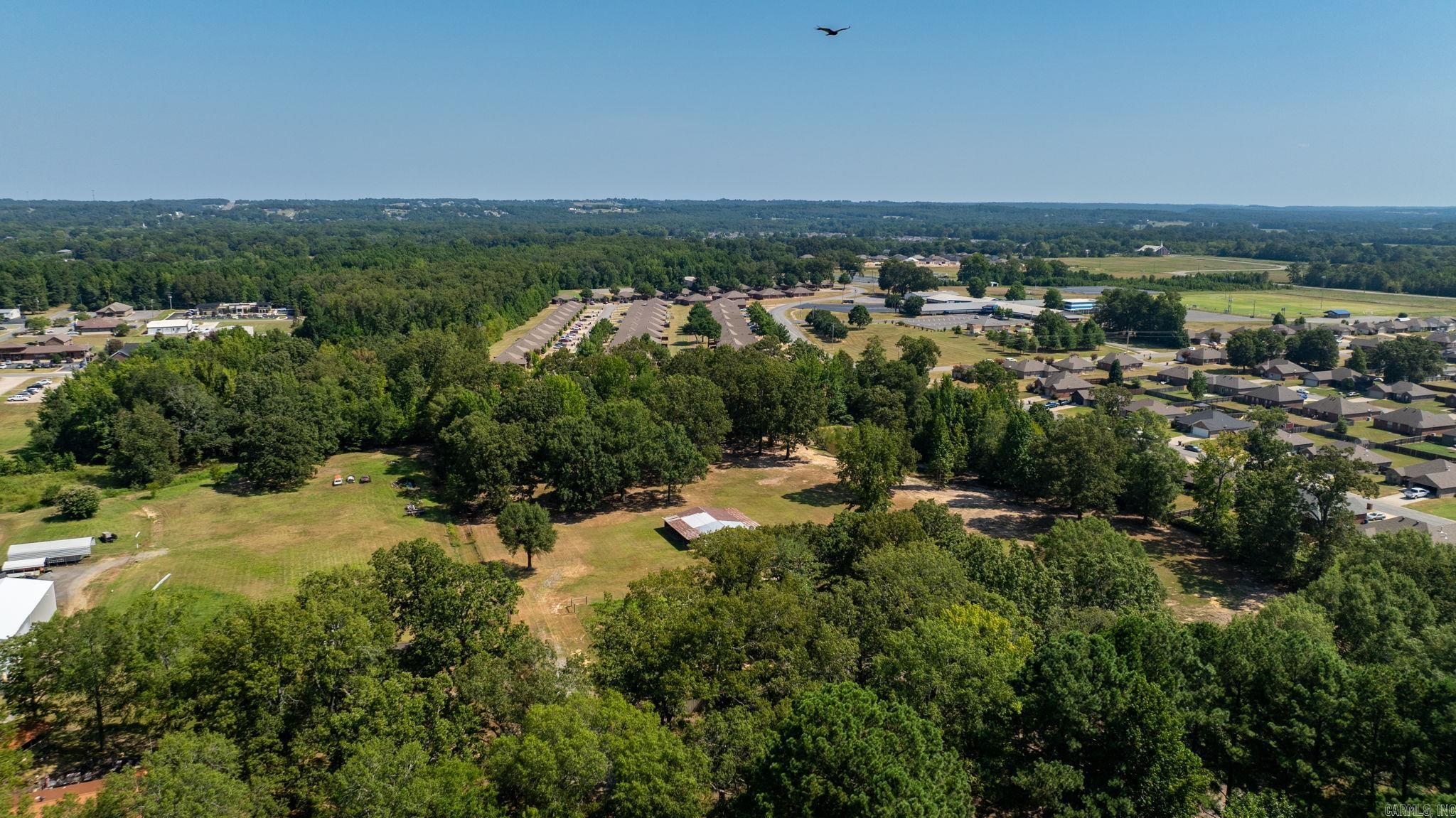 Attention Builders or Families wanting a large lot to build your dream home on.  This a rare find 6.11 Acres inside the Greenbrier City Limits.  This beautiful property offers cleared areas along with a pond for added charm.  Enjoy the convenience of city water, sewer and Entergy at the road, plus fiber optic internet for high-speed connectivity.  A wooded area provides natural privacy while still being close to all the amenities of town.  Whether you're looking to develop or build now or secure the land for the future, this property offers the perfect blend of space, convenience and tranquility. Motivated Seller!!!  Call for you private showing today!