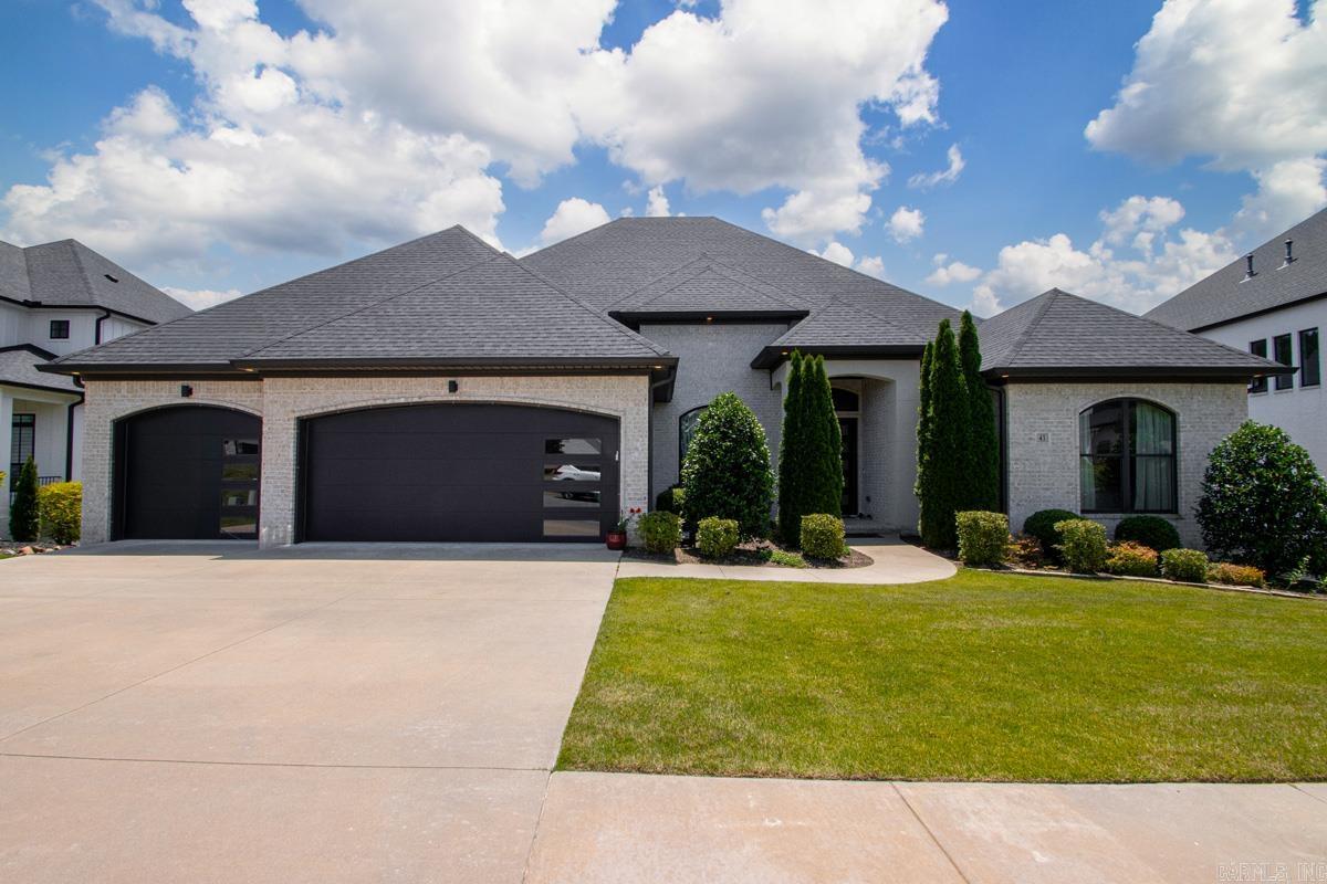 Gorgeous newer construction in the prestigious Falstone Chenal community. With exceptional street appeal and elevated finishes, the thoughtful floor plan features three ensuite first floor bedrooms and a fourth bedroom/office with a half bath. Tall ceilings, eight foot doors, detailed moldings, and custom finishes create an elegant feel throughout. The spacious living area features a fireplace, built-ins, surround sound, and seamless access to a large covered patio with grill station and surrond sound overlooking a private wooded setting. A special feature of this home is the fenced backyard which is only a few steps from the patio, creating a more usable outdoor space for pets, play, gatherings, or quiet evenings outside. The gourmet kitchen offers premium appliances, custom cabinetry, a large center island, and easy flow into the dining and breakfast areas. Luxurious primary suite with spa-inspired bath, two generous walk-in closets, and convenient access to the laundry room. Upstairs you’ll find a large game/media room and fourth ensuite bedroom and floored walk-in attic access.