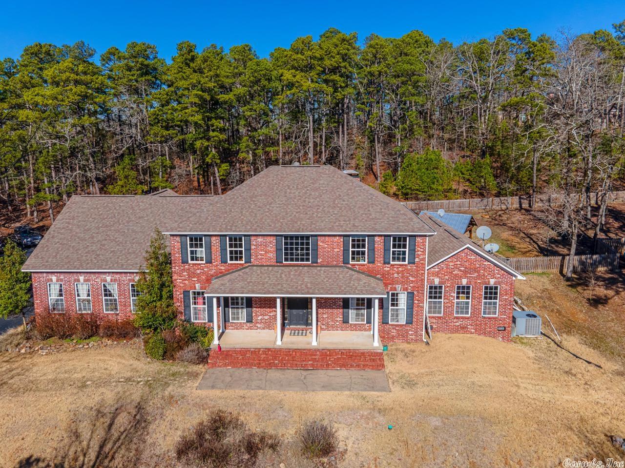 Beautiful traditional home situated on 5 acres in gated Ridgefield neighborhood. Country oasis just minutes from it all.  Enjoy the wildlife, salt-water pool with  multi-colored lights operated by app, hot tub and newly installed 14x14 pergola bolted to concrete!  Inside you will find light & bright soaring ceilings greeting you in the entry & family room.  Large kitchen offering a breakfast bar/island to host your gatherings. New SS double oven and microwave.  Wonderful entertaining space inside and out!  Dedicated office space. Master on main level. Site finished hardwoods.  3 car garage w/ample storage, encapsulated crawl space and an enormous bonus room upstairs w/kitchenette.  Don't miss the heated and cooled craft room in the garage which could be an office, closet, man cave or whatever you need. Roof replaced May 5, 2023