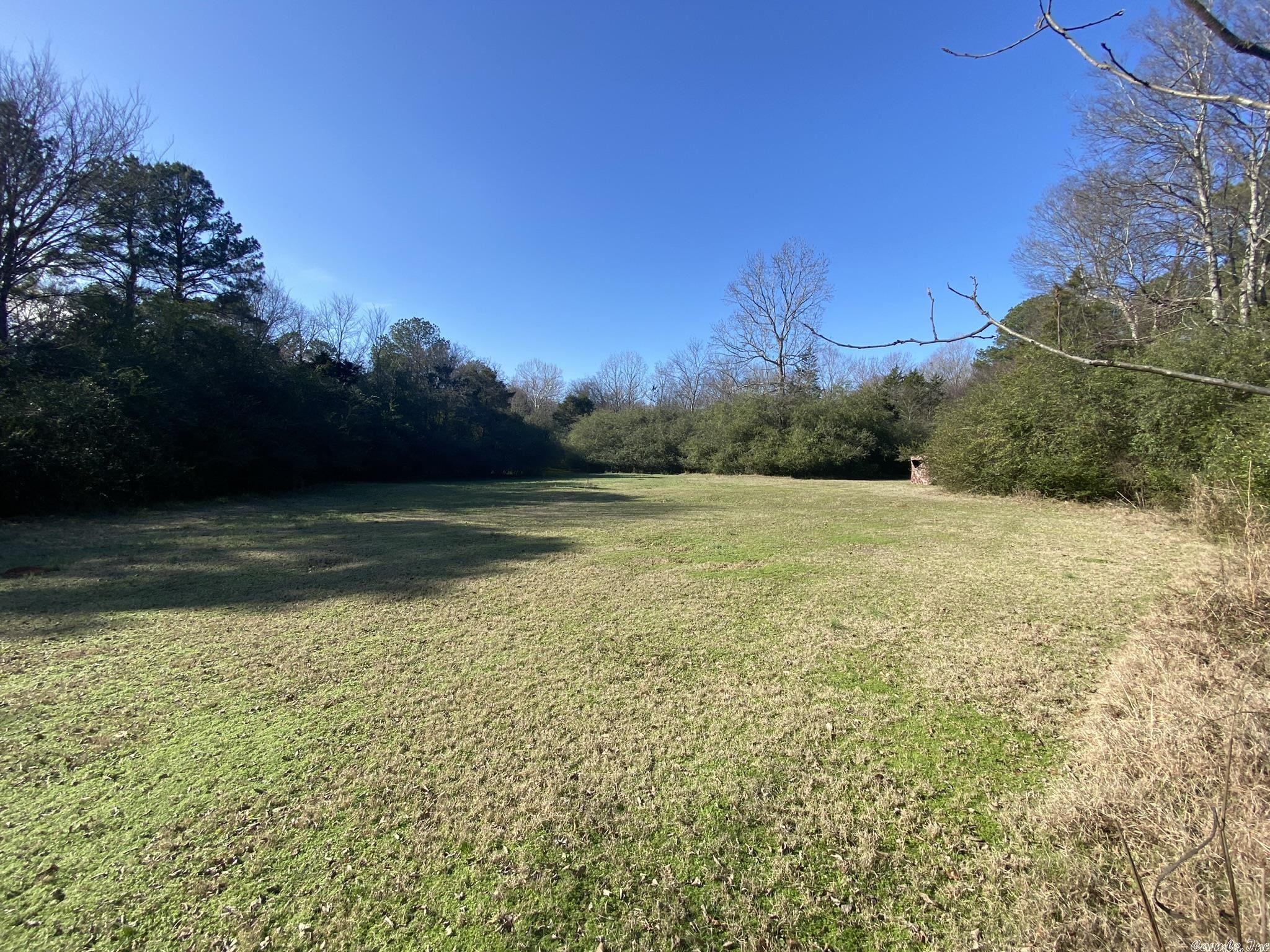 50 +/- acres of prime residential acreage adjoining the Bryant, Arkansas city limits. This tract has access on the East via Midland Road and at two points on the West side along Willow Street. The property has a pond, wet weather creek, and excellent timber. The property is lower in elevation around the pond on the East side, then gradually rises along hardwood ridges as you move to the West. This tract is perfectly suited for the individual looking to be 5 minutes from the interstate, yet build a custom home in the seclusion of a large parcel. As seen by the new subdivsion to the East, on Creekside Drive, this property is also well suited for development. The property has access to utilities from both sides although the Willow Street access lacks natural gas.