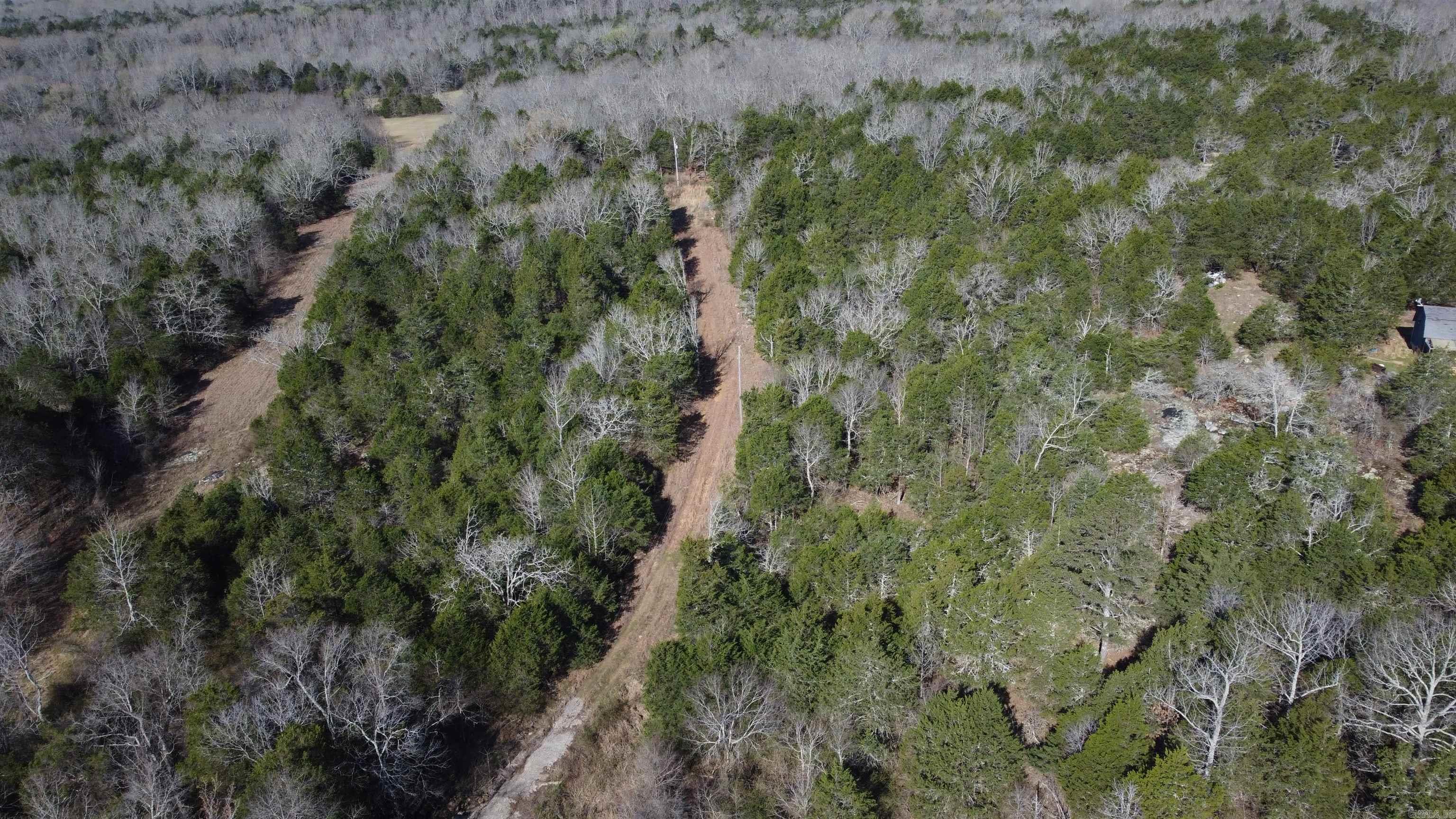 Hidden Creek Homestead Tract offers a quiet foothills retreat just northwest of Bradford in Jackson County. This unrestricted wooded property appears to have once served as a rural homesite, with an existing clearing and established roadway already in place. Power is located approximately 700 feet from Jackson County Road 5, making future improvements practical.  A creek crossing leads deeper into the timber where a private, secluded clearing creates the perfect setting for a cabin, new home, RV site, garden, or food plot. The tract is heavily wooded yet easy to traverse, providing excellent cover and habitat for deer, turkey, and other native wildlife.  With some timber stand improvement, trail development, and strategic game openings, this property could become an outstanding hunting getaway, weekend retreat, or private homestead location. If you’ve been searching for unrestricted acreage with nearby rural water access and strong recreational potential, this foothills tract deserves a closer look.