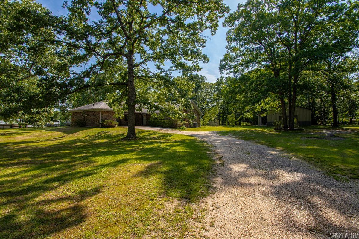 2145 sqft traditional home on 2.25 level acres featuring 3 bedrooms on the same level, spacious living room with wood-burning stove, kitchen/dining combo, and large laundry room. Primary bedroom includes dual ensuites. 24x30 shop with electricity offers great workspace potential. 2-car carport. Water heater replaced in 2025 and HVAC updated in 2017.