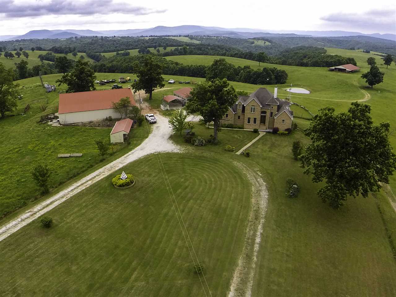 1,790 ACRE RANCH!! Luxurious 2 story, 2,945 sqft. brick home. Year-round creeks & springs, waterfalls, caves & 15 ponds. 75x40 insulated shop, two auto sheds, ATV shed, 40x100 hay barn, plus additional outbuildings. 500+ acres lush pasture, fenced and cross fenced with five sets of corrals. Set up for a hunting & recreational business including two new guest cabins, meat processing locker & walk-in freezer, very nice hunting blinds & regular deer stands.  Wildlife all over!! Close to the Buffalo River.