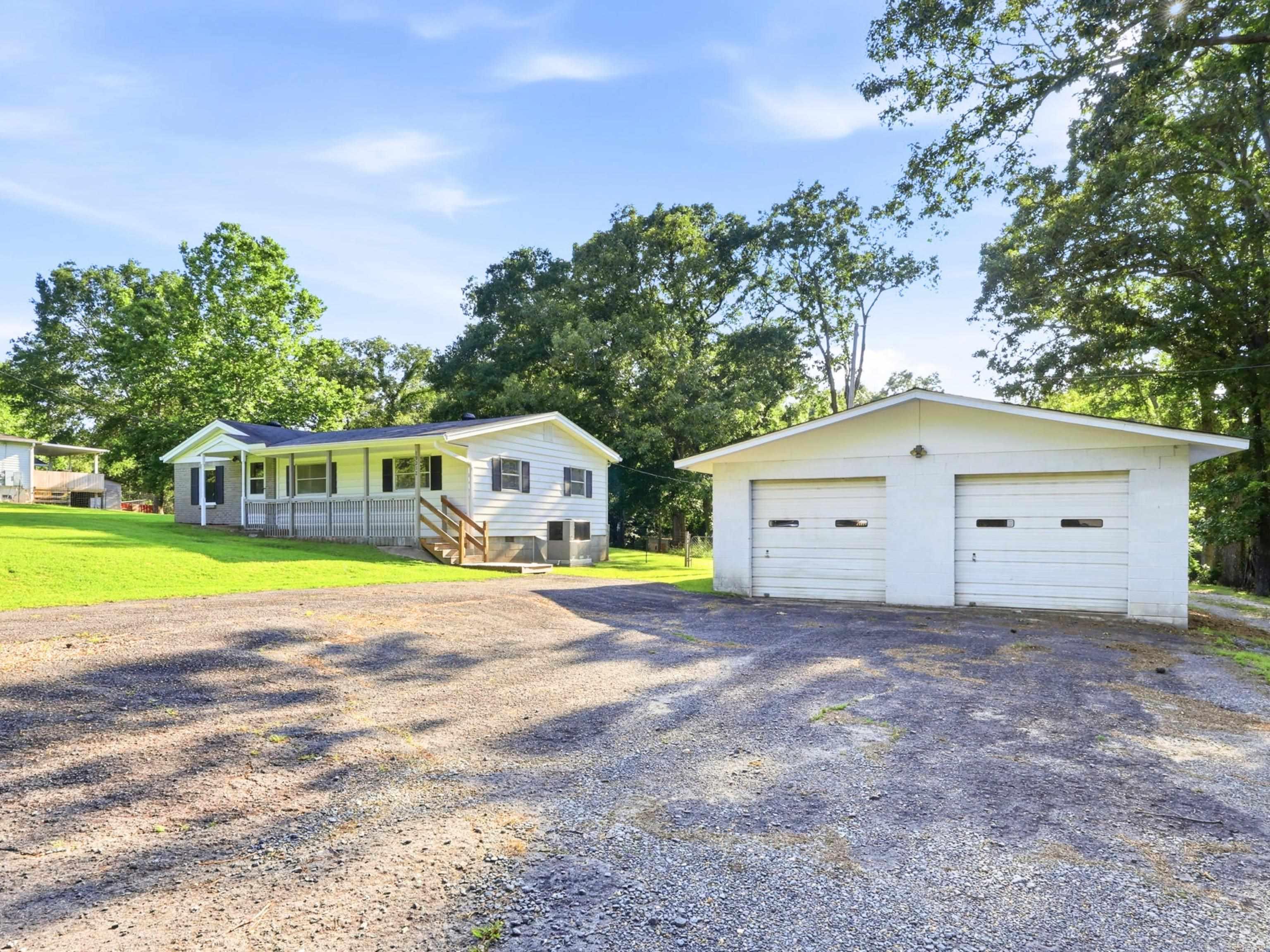 Welcome to 19212 Lawhorn Drive... A 3-bedroom, 1-bath home move-in ready home with fresh paint, new carpet, gas stove, a three year old water heater and a 6-year-old AC unit. Refrigerator, washer, and dryer all stay. The best part is the heated two car garage/shop. Perfect for a first-time buyer or a second home to work on your vehicles, store your equipment, park your trailer or RV, woodwork, or a start to a side business. The space is yours!! And while it feels like your own tucked-away oasis on 0.84 acres, everything you need is still close... grocery stores, auto shops, everyday errands, all just minutes away. Not the city. Not the country. Just the right in between. Live here. Work here. Build something here... literally.
