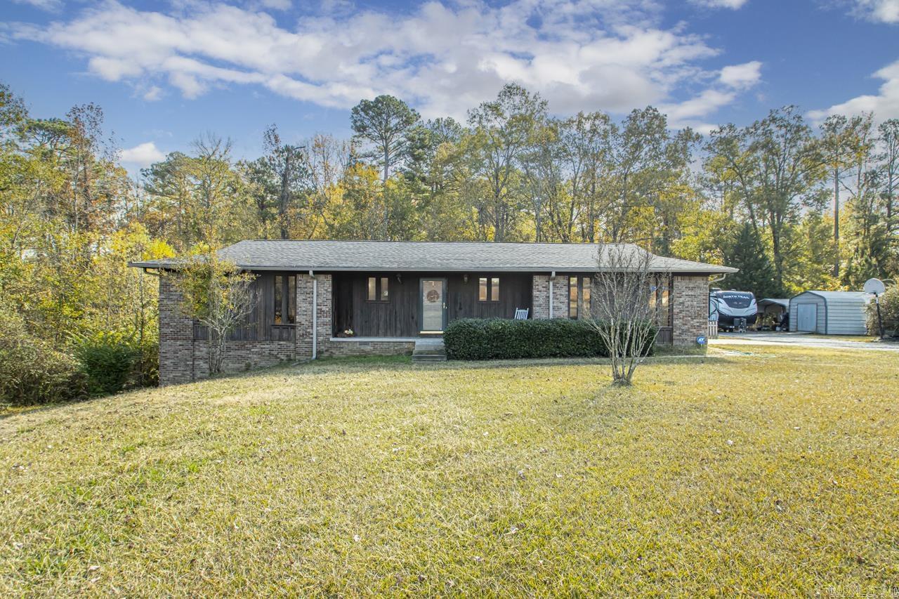 Charming Rustic home sitting on a beautiful piece of property. 3 bedrooms on main level and an a walk out basement that could be used as a bedroom. Basement is finished out. Updated hall bathroom. This home features an open layout of kitchen, dining and living room. Front porch and small covered back porch. Small section of backyard fenced. Carport and small storage building/shop will remain with property. 2 car garage. Roof replaced about 8-10 years ago. HVAC less than 3 years old. HWH less than 3 years old. Please see remarks.