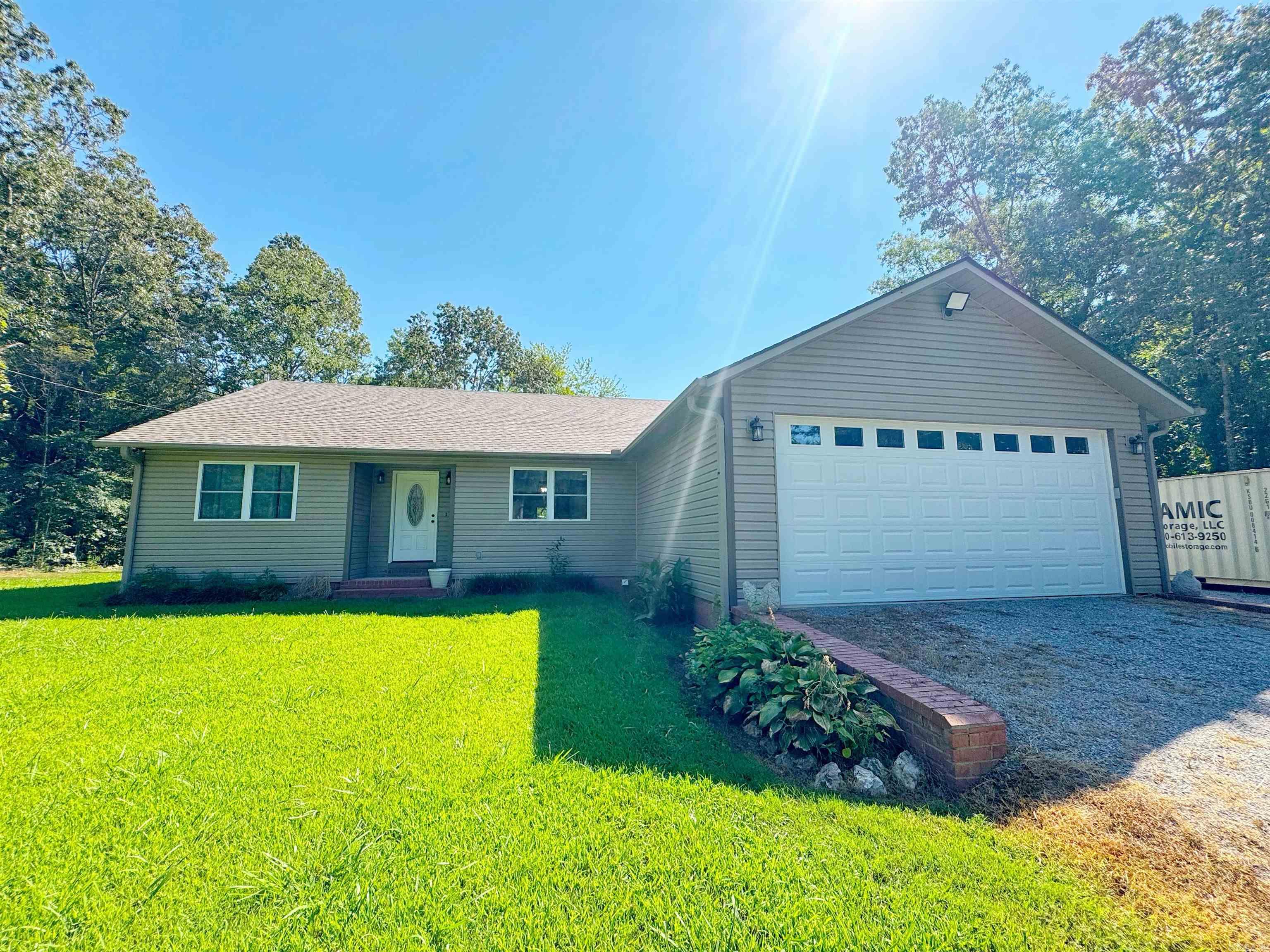 RARE OPPORTUNITY to live ON A LAKE located approximately 15 minutes to Batesville (shopping, restaurants, hospital)! This impeccably maintained home is a show stopper! Think LAKE VIEW while you cook! The updated kitchen is a cooks delight offering custom cabinetry with pull outs, granite countertops, and pantry cabinets. The vaulted ceiling living room provides an extra spacious feel and also offers an expansive lake view! Not enough lake view? Enjoy it from your primary ensuite as well, which offers an attached bath and well appointed walk in closet! Outside, enjoy the back deck or walk a few stops to relax on the dock! The garage is heated and cooled with a mini split. Perks abound with this end of the road property!