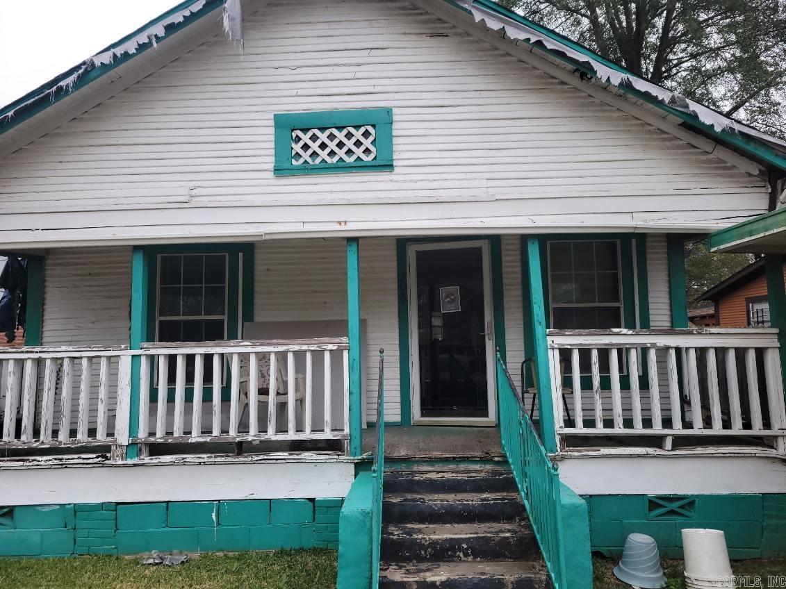 Bungalow Fixer... Bring your hammer and a new vision for what this once cute cottage could become again.  Nice open living dining and kitchen, lovely covered front porch. Two bedrooms.  This one will need a bit of everything...but its in a very convenient location! Being sold as-is.