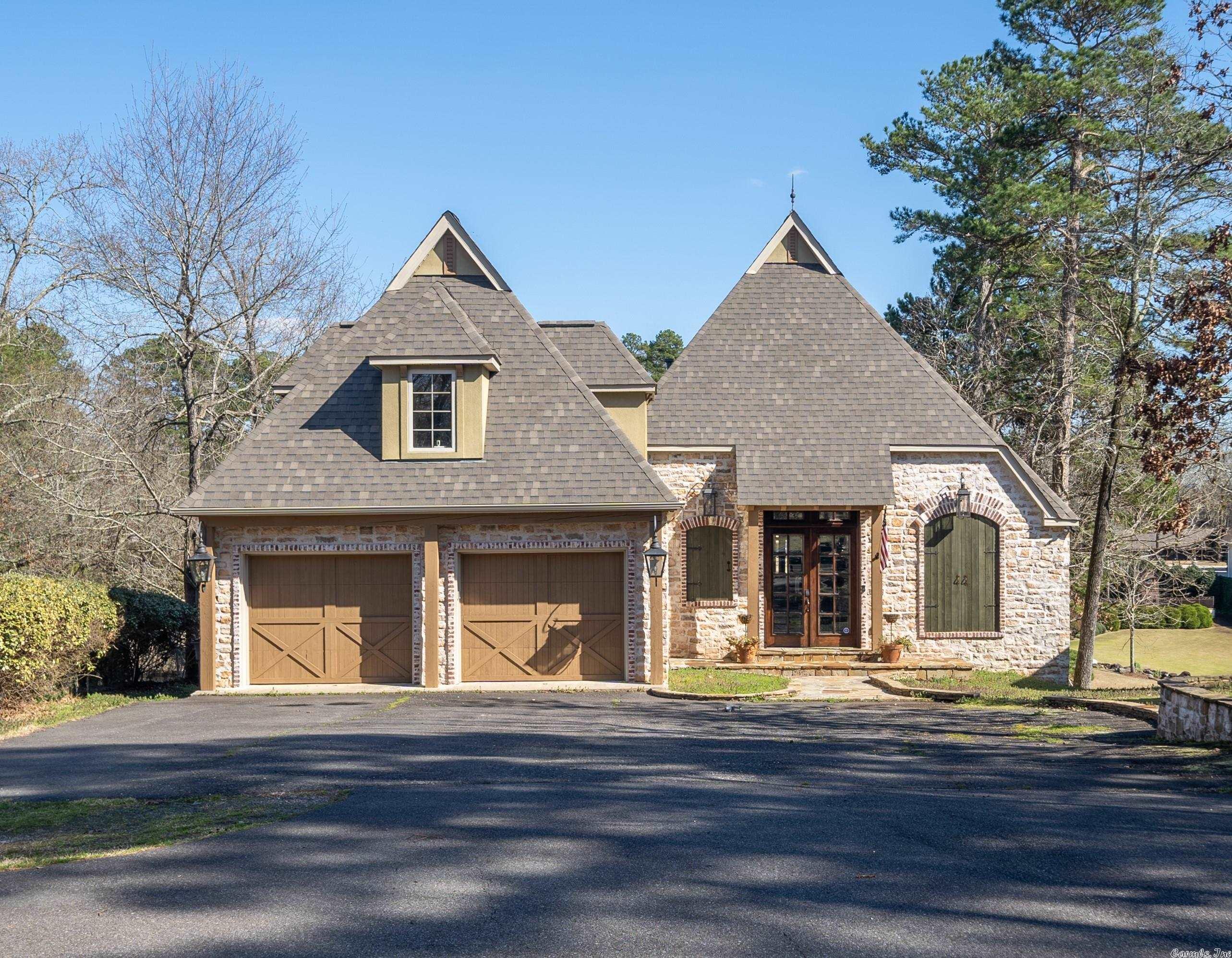 BEAUTIFUL CUSTOM BUILT HOME ON LAKE HAMILTON! Conveniently located on the highly coveted Peninsula Drive. Imagine relaxing on one of the 2 expansive covered patios with outdoor fireplace just steps away from the water. This 3,704 sq ft home features 4 bedrooms, 3.5 baths with custom finishes throughout. So many extras with this one -vaulted ceilings, chef's kitchen, granite and hardwoods throughout with tons of storage. Downstairs has separate living room with full kitchen and 2 bedrooms with 1 bath.