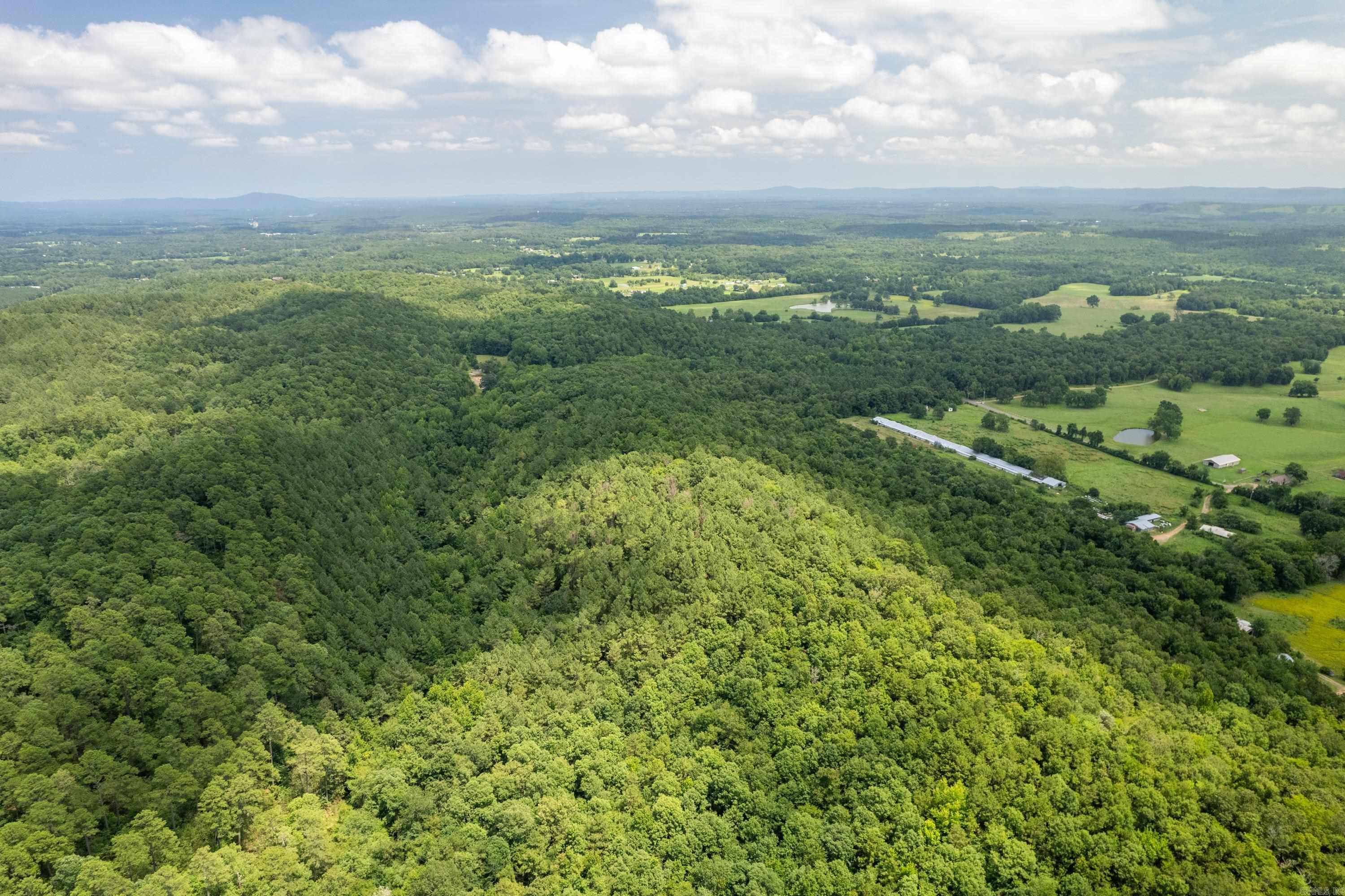 Sprawling 41.76-Acre Mountain Retreat Bordering National Forest! Discover your own private sanctuary on Ragweed Valley Road. This expansive 41.76-acre wooded parcel boasts stunning vista views and offers the ultimate canvas to build your secluded dream home or a premier hunting cabin. Includes deeded private land extending from Ragweed Valley Road to the front of the property, providing ample space for a private driveway and utility installation. The entire back boundary borders the Ouachita National Forest, offering endless recreational opportunities right out your back door. Featuring striking terrain with large, majestic boulders near the crest. Situated in the highly desirable Lake Hamilton School District. Enjoy the perfect balance of serene privacy while being just minutes away from both Lake Ouachita and Lake Hamilton.