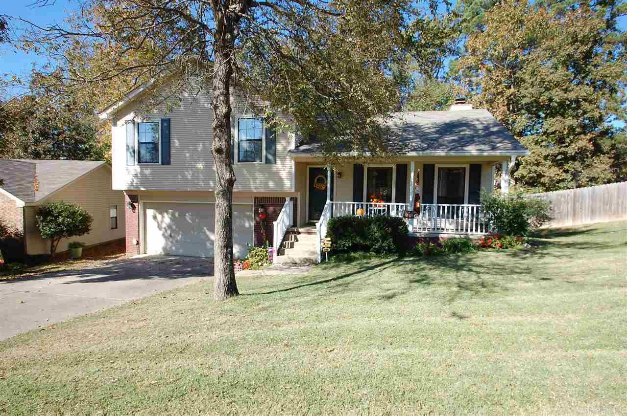 What a dollhouse!!  You enter into the den with a soaring ceiling, gas log FP, and wood laminate floors.  Opens to eat-in area and kitchen with stainless steel appliances!  New carpet.  Master has updated bathroom and large walk-in closet.  Laundry room downstairs.  New deck invites you into a very large backyard (extends past the short picket fence) that feels like a park!  2 car garage with extra storage.  New roof 2013.  Ready to move into!!