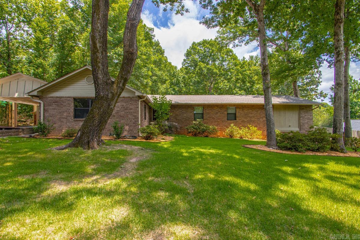 This charming 3-bedroom, 2-bath home offers the perfect blend of comfort, privacy, and outdoor living. Inside, you'll find a spacious and inviting layout with well-sized bedrooms, a functional floor plan, and plenty of natural light throughout. The primary suite features a private bath, while the additional bedrooms provide flexibility for family and guests with another room that is being used as an office.  Outside, the property continues to impress with a large 2-car carport that offers convenient covered parking and additional storage space. The backyard is a true highlight, featuring a beautiful deck that's perfect for relaxing, entertaining, grilling, or enjoying your morning coffee. Surrounded by nature, the deck overlooks a peaceful wooded area, creating a private retreat with scenic views and a tranquil atmosphere. With no rear neighbors and mature trees providing shade and beauty, you'll enjoy a sense of seclusion while still being close to everyday conveniences. Whether you're hosting gatherings or simply unwinding after a long day, this home offers the ideal setting for comfortable living both indoors and out.