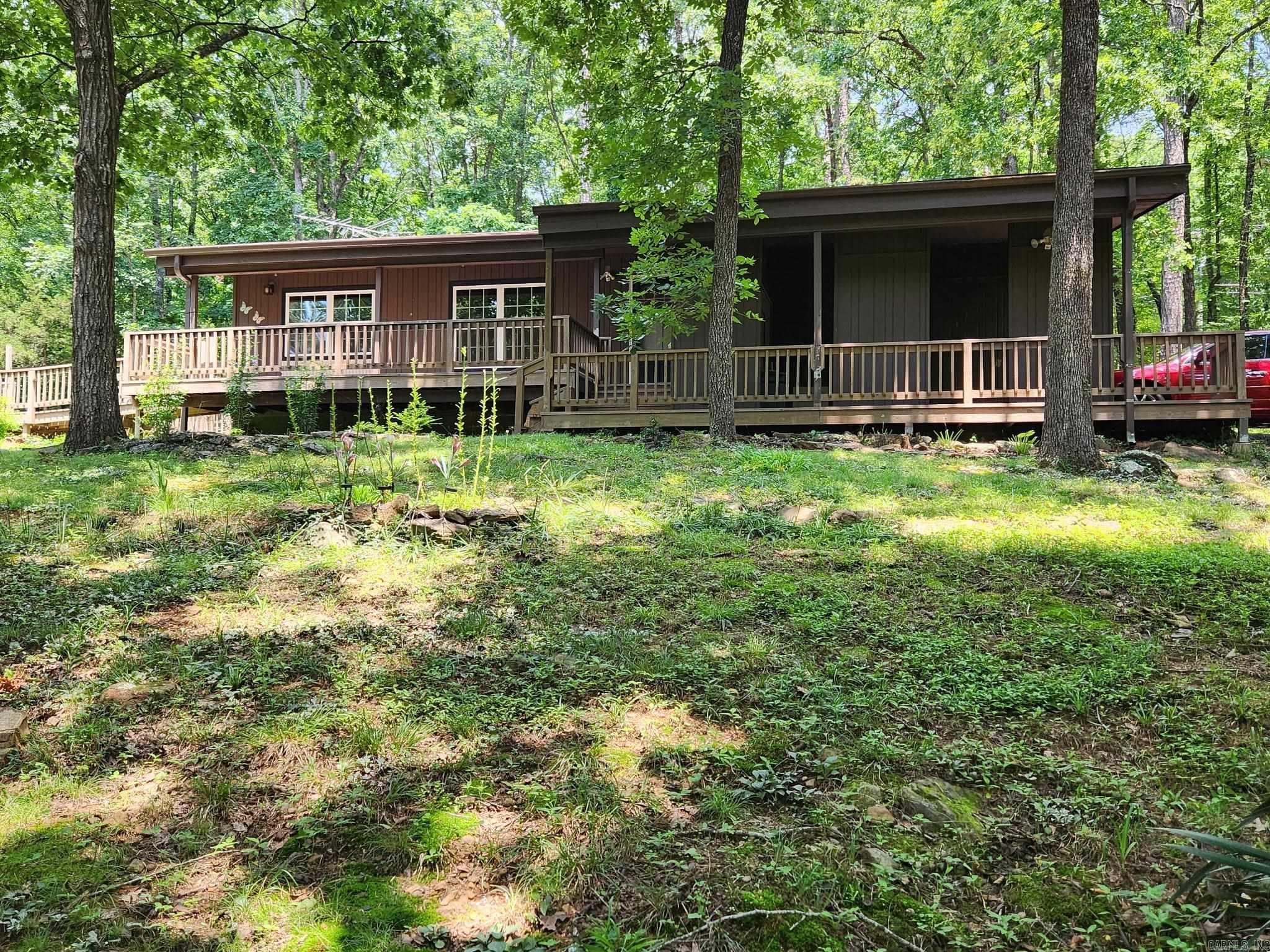 In the heart of Fairfield Bay nestled among the trees for complete privacy & at a dead end street that also adds to the secluded feel, lays this great home where you will enjoy the sights and sounds of wildlife but also realizing the safety of having neighbors you can't see.  Lounging on the covered front porch will be your new hobby & a enjoyable one at that.  Nearly new appliances remain which includes washer/dryer/refrigerator along with the range, microwave & dishwasher, new cabinets with pull-outs, composite countertops & tile black-splash, newly remodeled bath that will delight you, WB fireplace with circulating vents, generator wired, 14x24 heated/cooled workshop/craft rm or even could be used as extra sleeping space, gazebo & garden space. A short golf cart ride to golf course, many ATV trails to enjoy, swimming pools, tennis courts & pickle ball.  Don't forget the wonderful Gym very near and a senior citizen center if you are so inclined. Harps Grocery Store, restaurants, gas stations all for your convenience.  FFB dues only $113 monthly includes trash pickup.