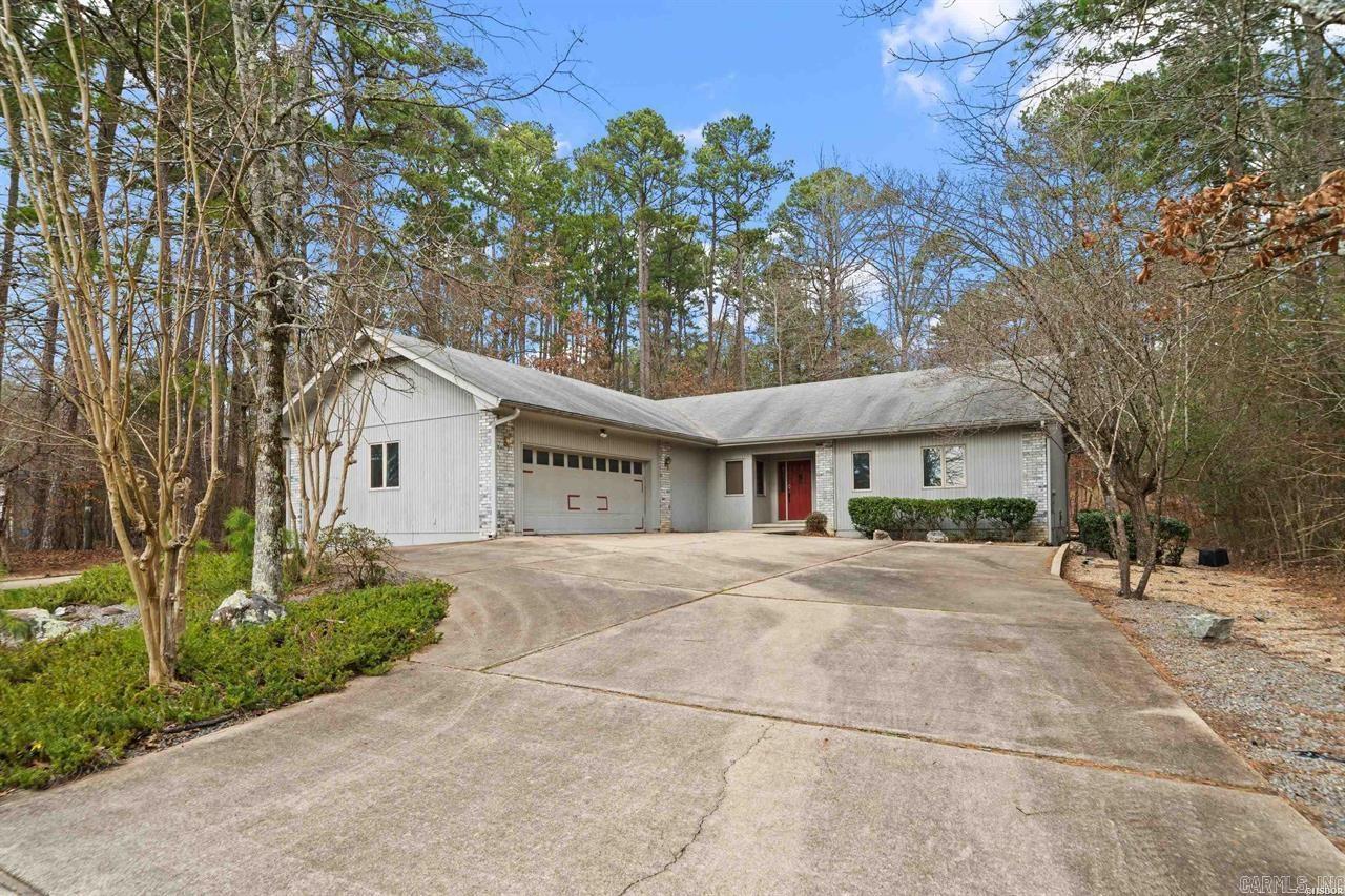 Beautiful one-level home in the gated community of Hot Springs Village. This home is located just two minutes from the Lake Pineda boat launch. This 3-bedroom, 2.5-bath home offers 2,217 square feet of comfortable living space. One bedroom features an additional adjoining room, perfect for a home office, sewing room, or hobby space. Enjoy relaxing in the sunroom overlooking the backyard, ideal for year-round enjoyment. The sunroom also features a bar area complete with a mini refrigerator, perfect for entertaining. A two-car garage and circular driveway provide ample parking and convenience.