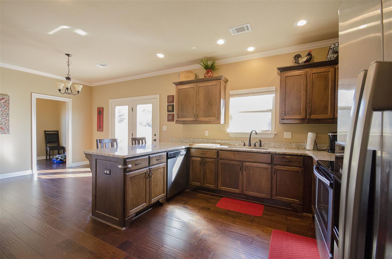 Gorgeous Family Home with Scenic View Outside of Town! This 3 bed/ 2 bath home has an office nook, formal dining room, recessed lighting, and beautiful dark hardwoods! Let your inner chef shine in the kitchen with custom cabinets and granite counter tops. It even comes with a spacious back deck, and is close to fishing ponds and hiking trails. Call today to schedule your private tour!