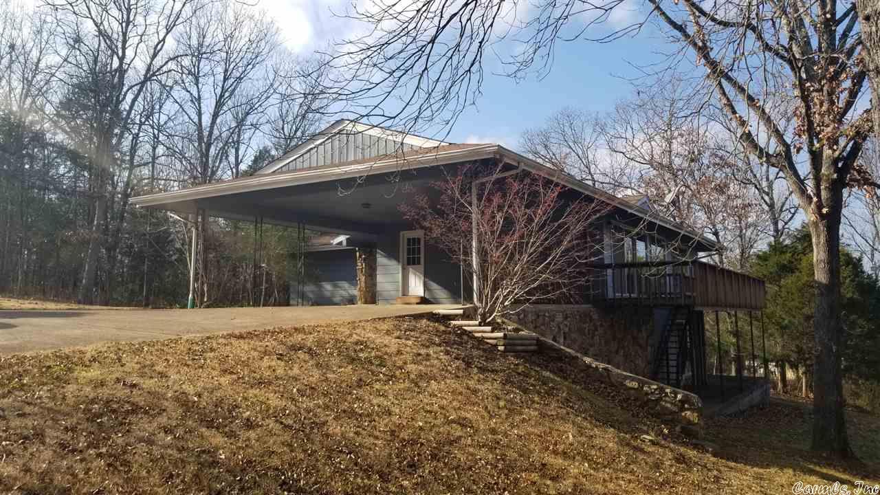 3 bedrooms and a full bath, plus a 3/4 master bath on the main level.  Lower level is partially finished, incl a shop area, 3rd full bath, possible 4th bedroom and bonus room which could be den/office/playroom, plus another living area.  Lower level patio and main level deck.  Lg 2 car carport, private lot near North golf Course and Town center/community center.  Hardwood floors in dining room, and all 3 bedrooms on main level.  Fireplace in the carpeted living room.  Formal dining area