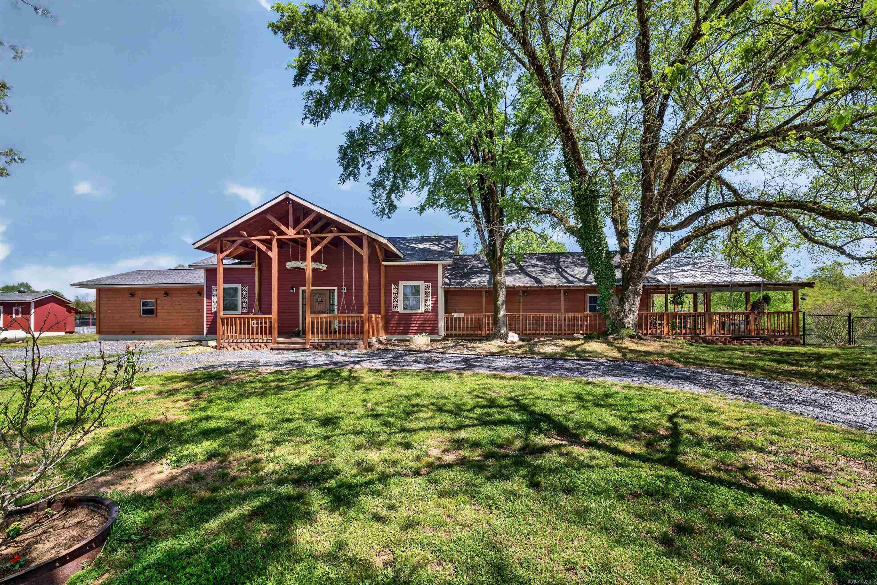 Step into craftsmanship and comfort with this immaculate home set on 5 beautiful acres, ideally located directly across from Dragover Road and just a stone’s throw from the Ouachita River. Designed with both luxury and functionality in mind, this property features two spacious primary suites and three full bathrooms, offering flexibility for guests or multi-generational living. Inside, you’ll find custom cabinetry and stunning woodworking throughout, showcasing exceptional attention to detail and timeless quality. Relax and unwind on the expansive front porch with over 500 square feet, perfect for morning coffee or taking in peaceful surroundings. Outdoors, the property continues to impress with a top-tier  chicken coop that adds charm and personality, along with a storm cellar for added peace of mind. For those looking for even more space, additional acreage is available for purchase. This one-of-a-kind property blends refined living with country charm in a prime location near the river—where every detail has been thoughtfully crafted and beautifully maintained. *** Home will be listed with additional acreage as well.